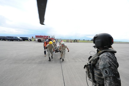 Honduran firefighters bring a litter to a waiting UH60 helicopter during an exercise June 7, 2011, at Soto Cano Air Base, Honduras. The exercise, called Central America Sharing Mutual Operational Knowledge and Experiences, or CENTAM SMOKE, allows U.S. and Honduran firefighters four days of team-building training.   