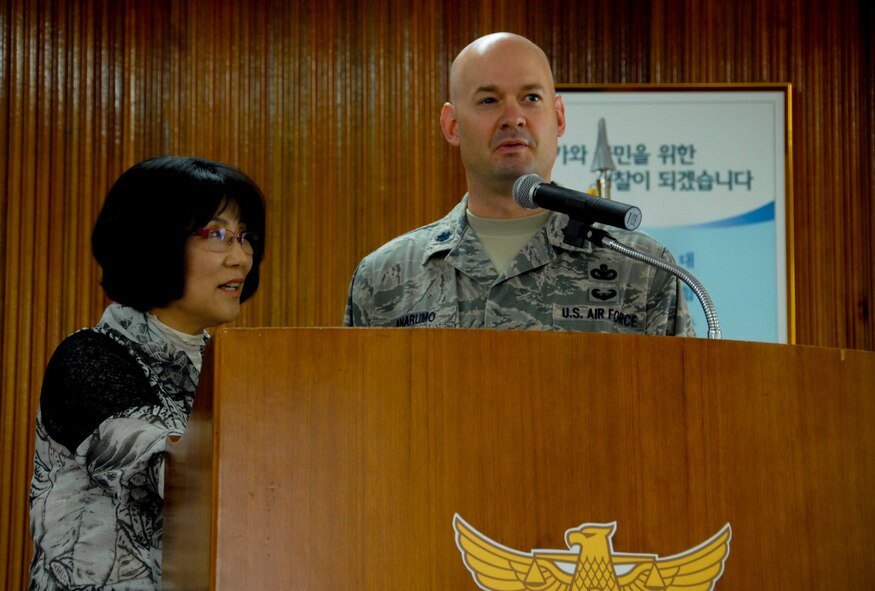 GUNSAN CITY, Republic of Korea -- Ms. Yi Chom-Sok, 8th Security Forces Squadron Korean liaison, translates as Lt. Col. Mark Anarumo, 8th SFS commander, answers questions from the audience following his presentation to the Gunsan City Korean National Police on the routine activity theory here June 7. (U.S. Air Force photo/1st Lt. Trisha Eldredge)