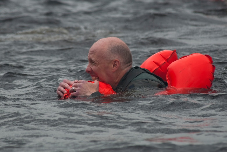 Lt. Col. Daniel E. Gabrielli swims gripping his aircrew life preserver in the bone chilling waters of the St. Croix River during water survival training 11 June, 2011 in the St. Croix River Afton State Park, Hastings, Minn. Sixty-two members of the 133rd Airlift Wing, Minnesota Air National Guard are taking part in their annual survival training at Afton State Park, Hastings Minn. including survival equipment, lift raft familiarization, parachute disentanglement and rescue techniques. U.S. Air Force Photo by Tech. Sgt. Erik Gudmundson (released)