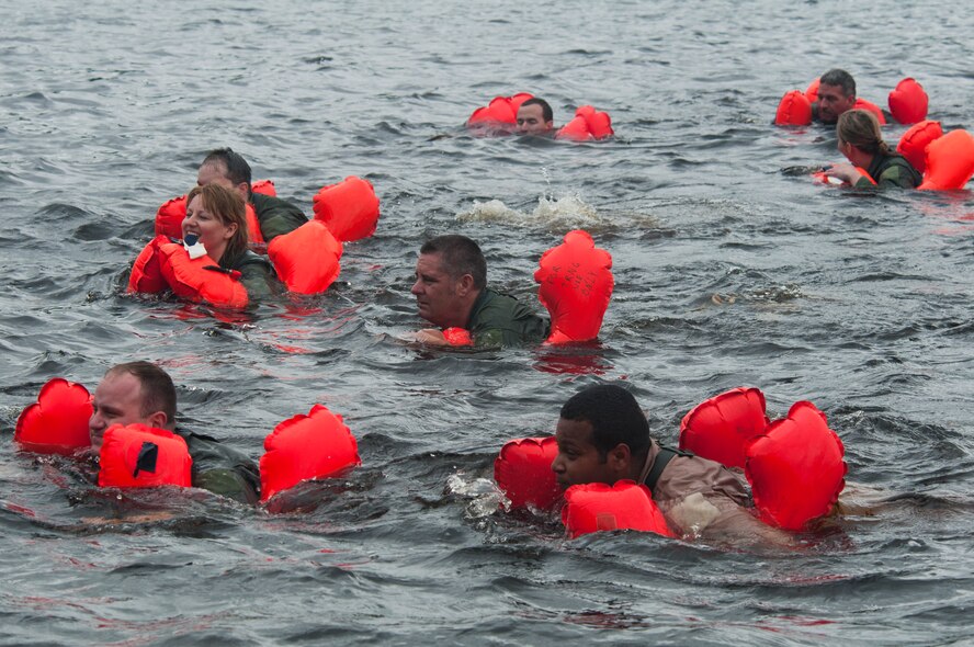 Air Crew members swim in the frigid waters of the St. Croix River with their aircrew life preserver keeping them afloat. Sixty-two members of the 133rd Airlift Wing, Minnesota Air National Guard are taking part in their annual survival training at Afton State Park, Hastings Minn. including survival equipment, lift raft familiarization, parachute disentanglement and rescue techniques. U.S. Air Force Photo by Tech. Sgt. Erik Gudmundson (released)