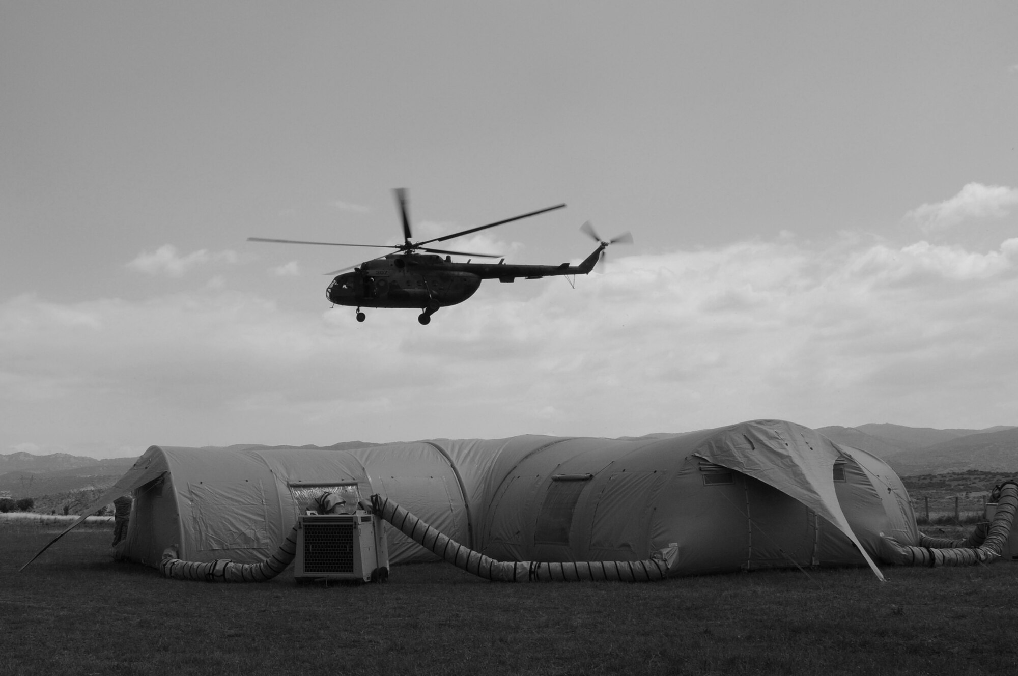 CAMP PEPELISHTE, Macedonia -- A Macedonian MI-17 hovers over a medical treatment facility during the 2011 Medical Training Exercise in Central and Eastern Europe live exercise June 11. An annual Chairman of the Joint Chiefs of Staff-sponsored regional and multilateral exercise, MEDCEUR is designed to provide medical training and operational experience in a deployed environment for U.S. and partner nations. The countries participating in this year's MEDCEUR are Macedonia, Montenegro, Bosnia and Herzegovina, Serbia, Slovenia and Norway. (U.S. Air Force photo/Staff Sgt. Julius Delos Reyes)