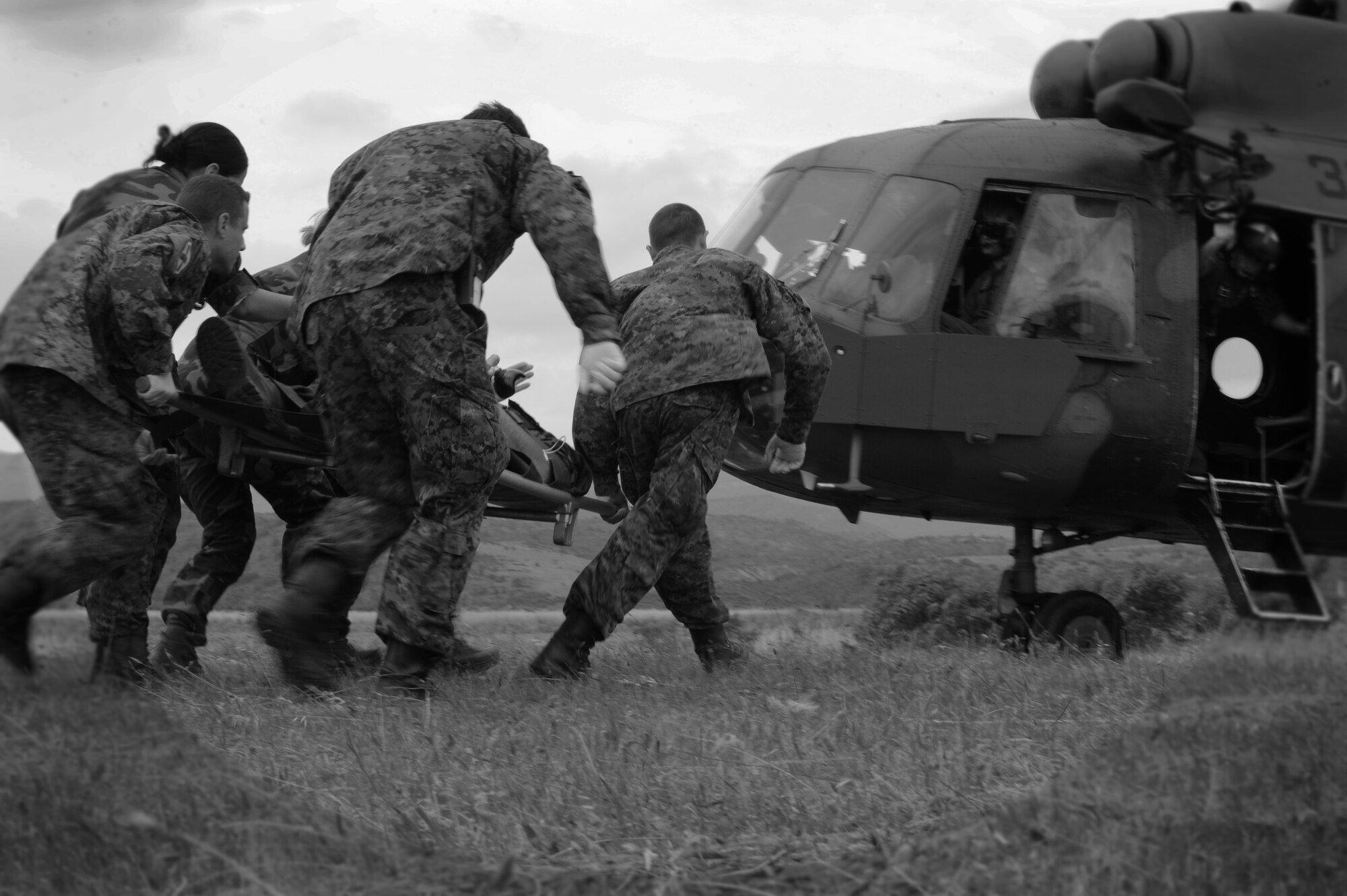 CAMP PEPELISHTE, Macedonia -- Multinational medical personnel race to a Macedonian MI-17 with a simulated trauma patient as part of a medical transport flight on a patient during the 2011 Medical Training Exercise in Central and Eastern Europe live exercise June 12. An annual Chairman of the Joint Chiefs of Staff-sponsored regional and multilateral exercise, MEDCEUR is designed to provide medical training and operational experience in a deployed environment for U.S. and partner nations. The countries participating in this year's MEDCEUR are Macedonia, Montenegro, Bosnia and Herzegovina, Serbia, Slovenia and Norway. (U.S. Air Force photo/Staff Sgt. Nadine Y. Barclay)