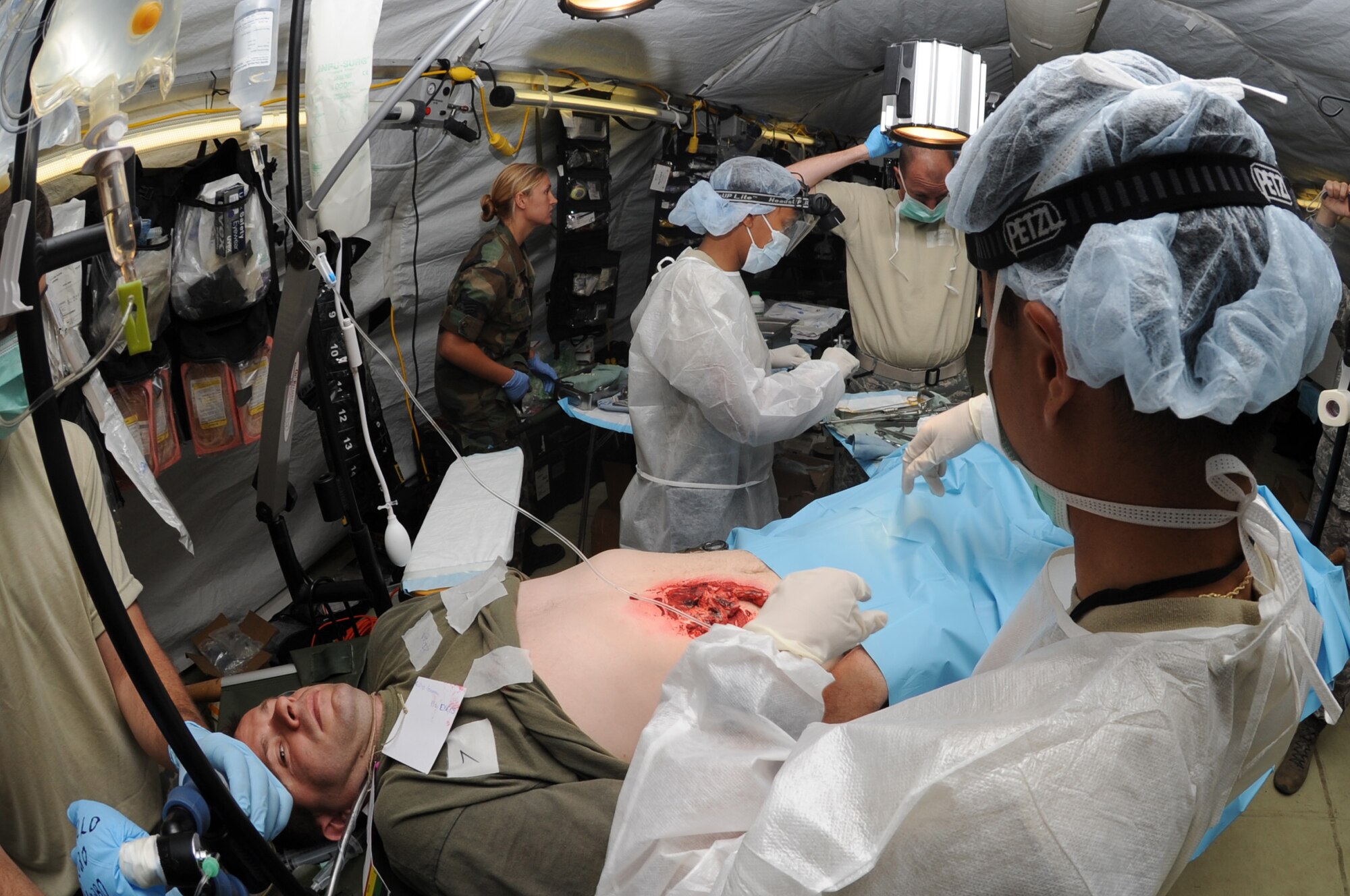 CAMP PEPELISHTE, Macedonia ? Maj. Peter Tran, 86th Medical Group urologist from Ramstein Air Base, Germany, and his surgical team prepare for simulated surgery on a patient during the 2011 Medical Training Exercise in Central and Eastern Europe live exercise June 11. An annual Chairman of the Joint Chiefs of Staff-sponsored regional and multilateral exercise, MEDCEUR is designed to provide medical training and operational experience in a deployed environment for U.S. and partner nations. The countries participating in this year's MEDCEUR are Macedonia, Montenegro, Bosnia and Herzegovina, Serbia, Slovenia and Norway. (U.S. Air Force photo/Staff Sgt. Nadine Y. Barclay)