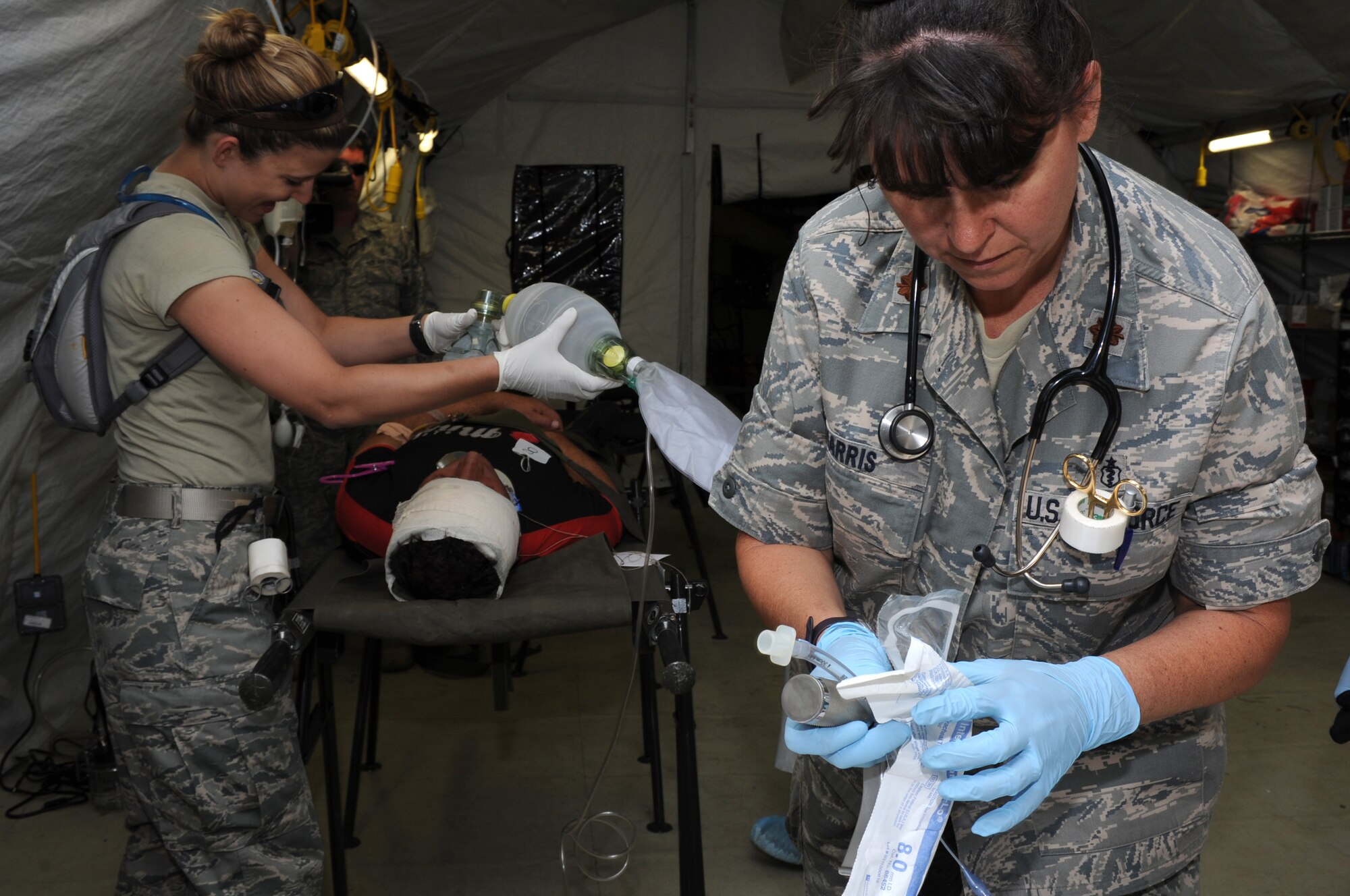 CAMP PEPELISHTE, Macedonia ? Maj. Cindy Harris and Capt. Kelsey Sweeny, 86th Medical Group nurses from Ramstein Air Base, Germany, prepare a patient for simulated surgery during the 2011 Medical Training Exercise in Central and Eastern Europe live exercise June 11. An annual Chairman of the Joint Chiefs of Staff-sponsored regional and multilateral exercise, MEDCEUR is designed to provide medical training and operational experience in a deployed environment for U.S. and partner nations. The countries participating in this year's MEDCEUR are Macedonia, Montenegro, Bosnia and Herzegovina, Serbia, Slovenia and Norway. (U.S. Air Force photo/Staff Sgt. Nadine Y. Barclay)
