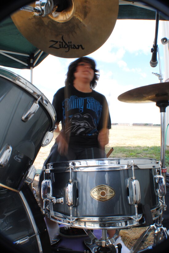 Gasoline Alley drummer, Avery Gutierrez, jams out a song outside the C-5 (Galaxy) Cargo Load Training Facility, June 4, 2011 at Lackland Air Force Base, Texas. The eleven-year old is a member of Gasoline Alley, a kid band from San Antonio, which provided entertainment for service members and guests attending a burger burn fundraiser for the 433rd Airlift Wing's 60th anniversary celebration taking place later this year. (U.S. Air Force photo/Senior Airman Luis Loza Gutierrez)