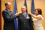 Lt. Col. Jack Wall, 151st Mission Support Group commander, is pinned to the rank of colonel during his promotion ceremony by Col. Samuel Ramsey, 151st Air Refueling Wing commander, and his wife Doreen. Photo by Tech. Sgt. Jeremy Giacoletto-Stegall. (RELEASED)