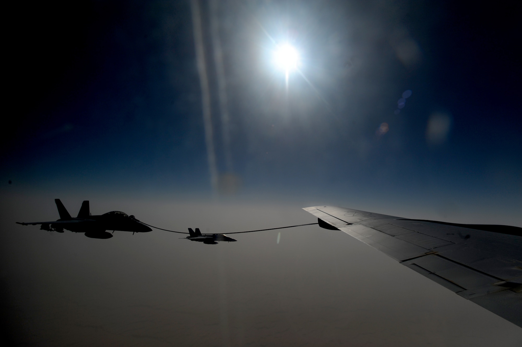 A U.S. Navy F/A-18 Super Hornet receives fuel via the multi-point refueling system on a KC-135 Stratotanker in the skies of Afghanistan during an air refueling mission supporting Operation Enduring Freedom. (U.S. Air Force photo/Master Sgt. William Greer)