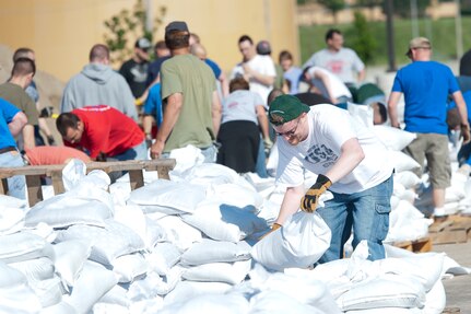 Military and civilian members of team Offutt and the local community fill sand bags in support of flood efforts in preparation of possible flooding in the near future at Offutt AFB and surrounding areas. For more information and reference links, see the <a href="http://www.stratcom.mil/flood_information/">USSTRATCOM Flood Information page.</a>