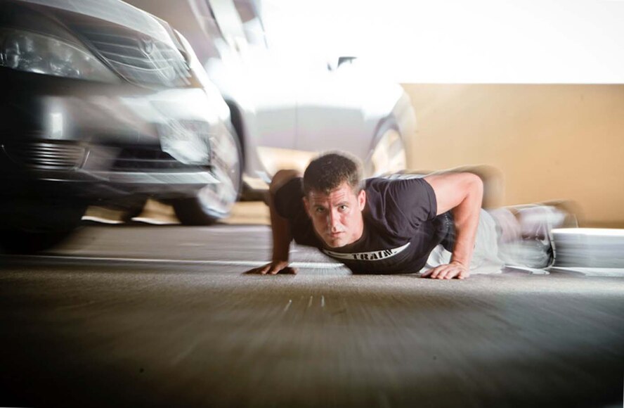 CAR STRIKES AIRMAN DOING PUSHUPS - When a car ran over an Airman doing pushups in a parking garage, the Airman suffered a severe right ankle sprain, contusions and lacerations to his right leg and left arm, and was placed on seven days quarters. (by Tech. Sgt. Samuel Bendet)