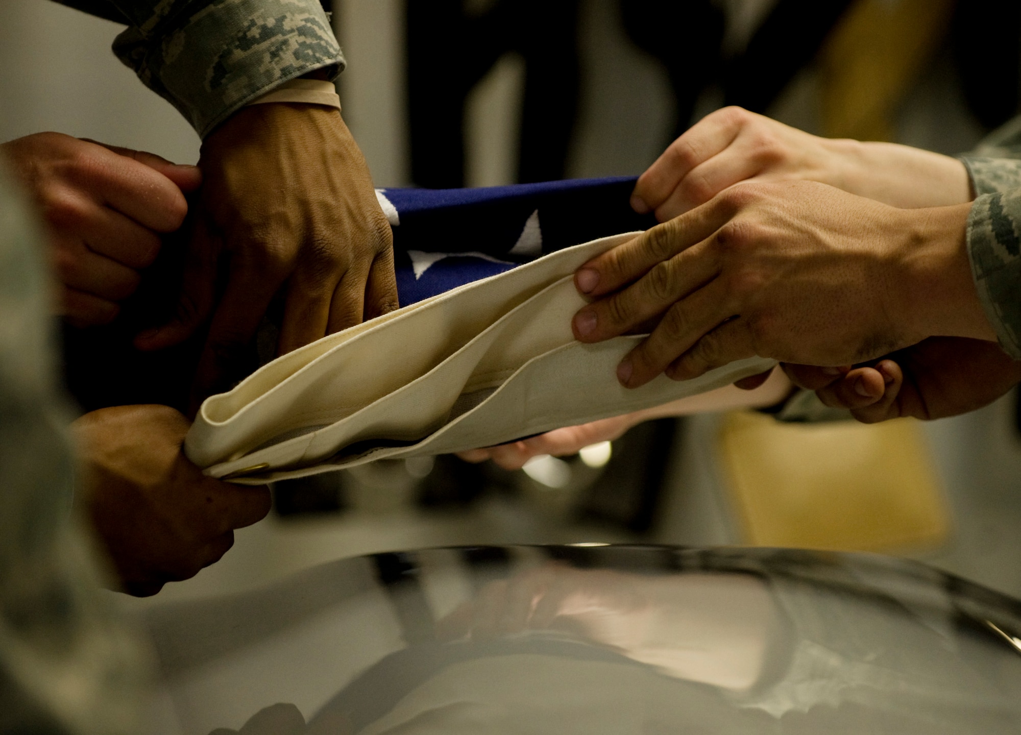 Eielson Honor Guardsmen fold a flag during training June 7, 2011, Eielson Air Force Base, Alaska.  Honor Guard members drill constantly to maintain the precision they are known for to honor fallen Airmen. The flag is folded 13 times; each fold has a symbolic meaning. (U.S. Air Force photo/Airman 1st Class Laura Goodgame) 