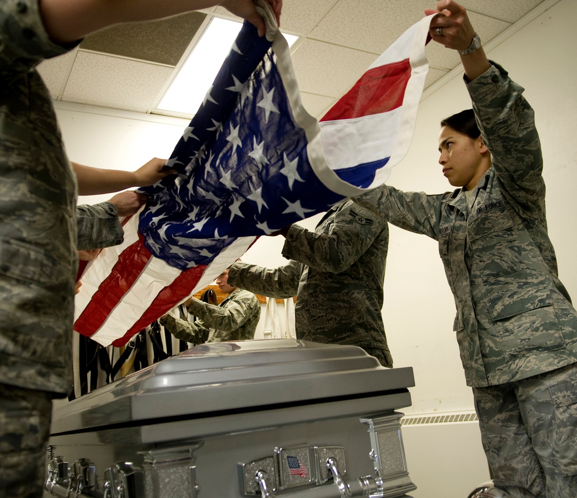 Eielson Honor Guardsmen fold the American flag during practice June 7, 2011, Eielson Air Force Base, Alaska.  Honor Guard members drill constantly to maintain the precision they are known for. The flag is folded 13 times; each fold has a symbolic meaning.  (U.S. Air Force photo/Airman 1st Class Laura Goodgame) 