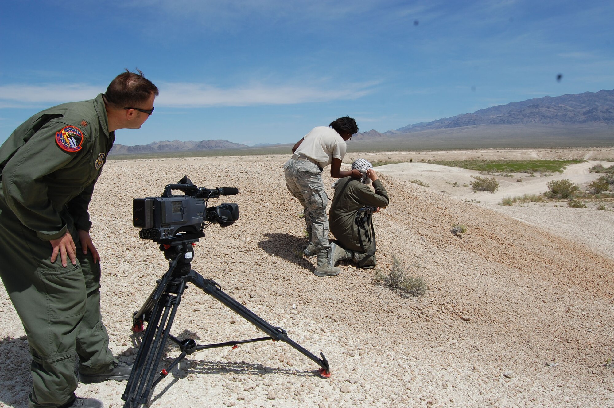 NELLIS AIR FORCE BASE, Nev. -- (Left) Maj. Christopher Vasquez, 926th Group, directs a shoot April 21 to compile footage for an updated mission video. (U.S. Air Force photo/Capt. Jessica Martin)