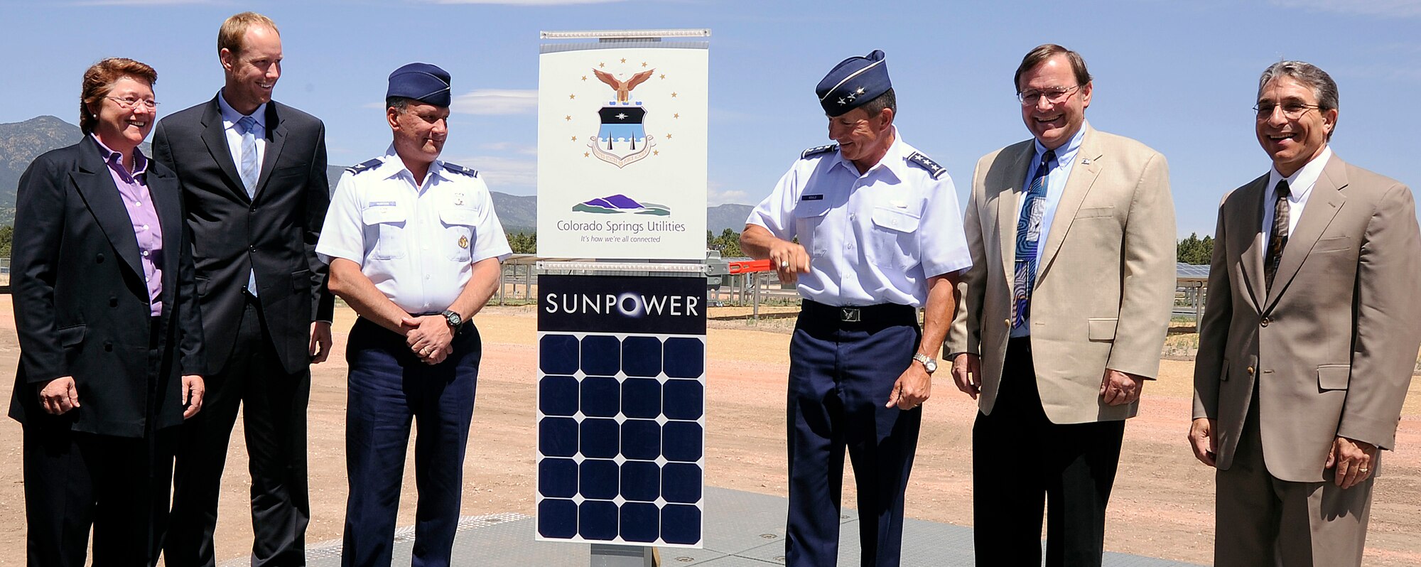 Lt. Gen. Mike Gould, third from right, flips a switch to signify the dedication of a 6-megawatt solar array at the Air Force Academy in Colorado Springs, Colo., June 13, 2011. General Gould is the Academy superintendent. Also pictured are 10th Air Base Wing Vice Commander Col. Todd Robison, third from left, and officials from SunPower Corporation and Colorado Springs Utilities. (U.S. Air Force photo/Mike Kaplan)
