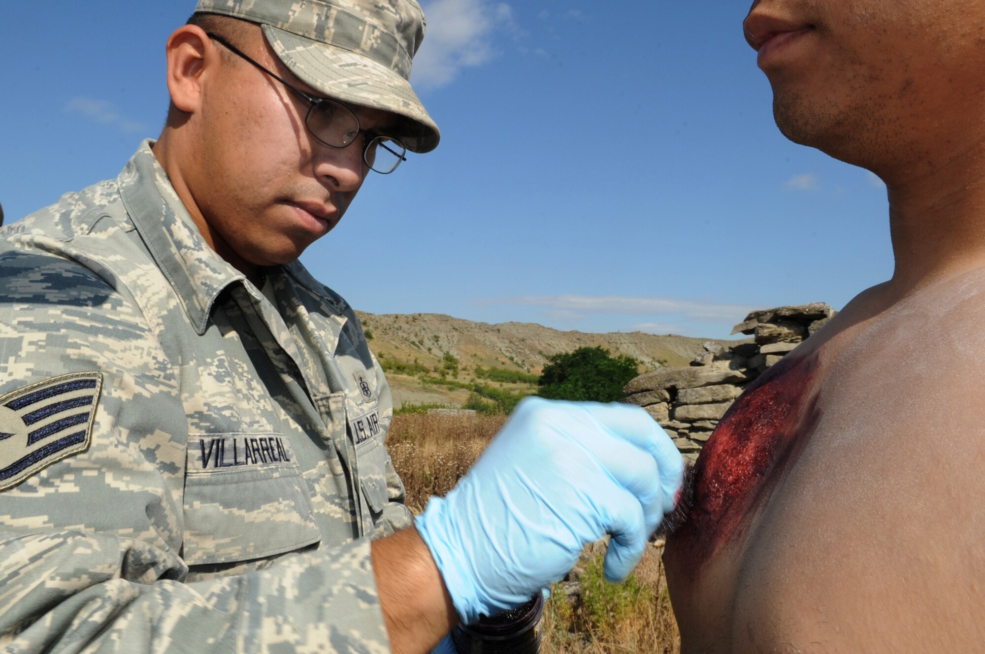 Staff Sgt. Ezequiel Villarreal prepares a "patient" for a simulated mudslide scenario during the 2011 Medical Training Exercise in Central and Eastern Europe Initial Contingency Response Team training day June 10, 2011, in Krivolak, Macedonia. Sergeant Villarreal is an 882nd Training Squadron Expeditionary Medical Support System instructor at Camp Bullis, Texas. (U.S. Air Force photo/Staff Sgt. Nadine Y. Barclay)