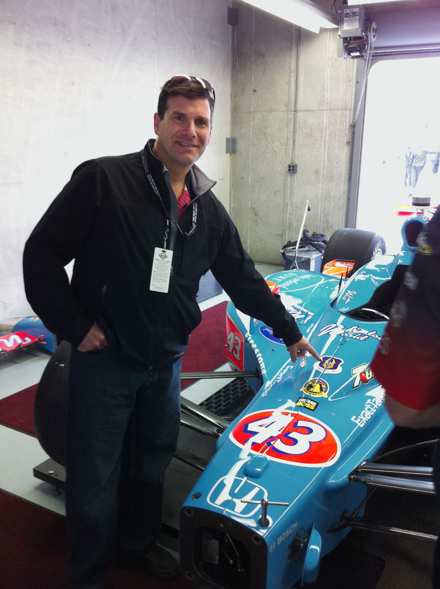 INDIANAPOLIS -- Col. Al Lupenski, 349th Operations Group Commander, points to the Air Force Reserve Command shield painted on Andretti Autosport’s number 43 race car at Indianapolis Motor Speedway, May 27, 2011.  (Courtesy Photo)  