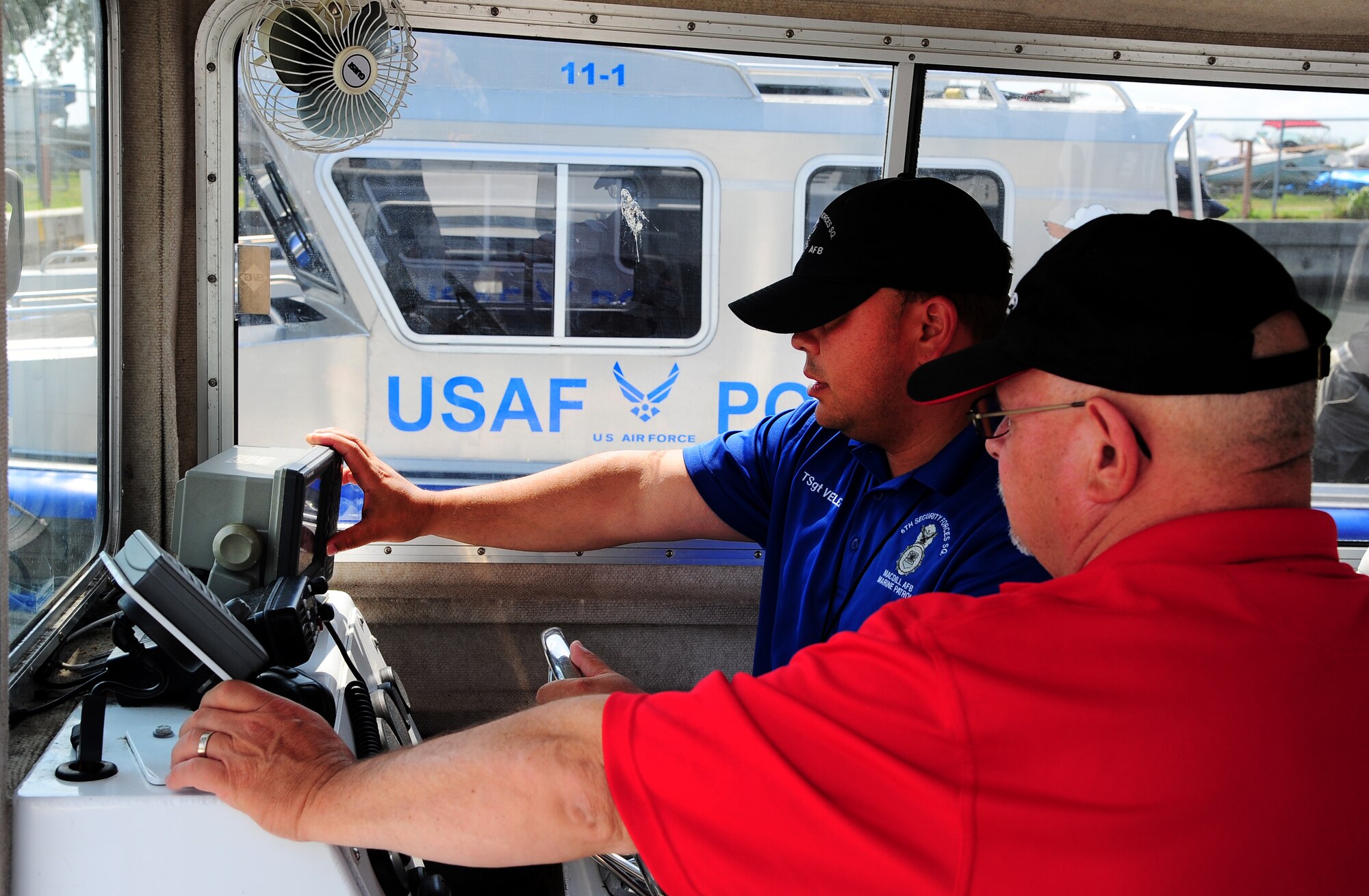 Tech. Sgt. Christopher Velez, 6th Security Forces Squadron marine patrol receives instructions on how to use the marine global positioning system from Mr. Brian Wells, National Association of State Boating Law Administrators instructor, at the MacDill Air Force Base marina, June 10, 2011. The instruction was part of the NASBLA Boat Operations and Training Program. (U.S. Air Force photo by Airman Basic David Tracy)