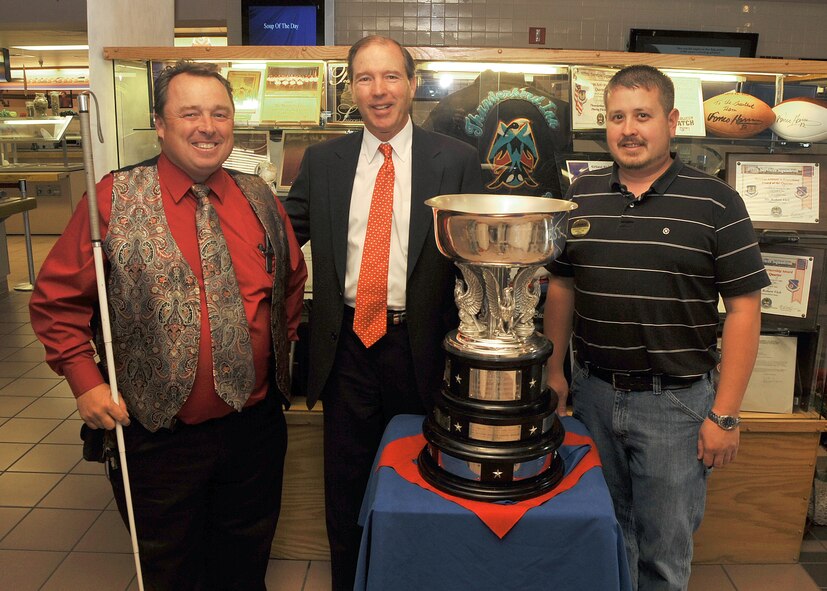 On his visit, Sen. Udall visited the Kirtland AFB dining facility and congratulated manager Robert Vick, left, and Daniel Lynn, of the 377th Force Support Squadron for winning the Hennessy Trophy.