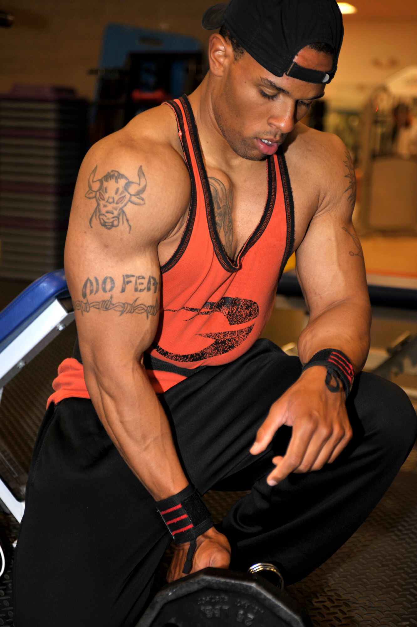 Staff Sgt. Christopher Wescott, a patrolman for the 27th Special Operations Security Forces Squadron, performs bicep curls at the Cannon Air Force Base fitness center May 9, 2011. Wescott has been competing in body building since 2009.  (U.S. Air Force Photo by Airman Ericka Engblom)(RELEASED)