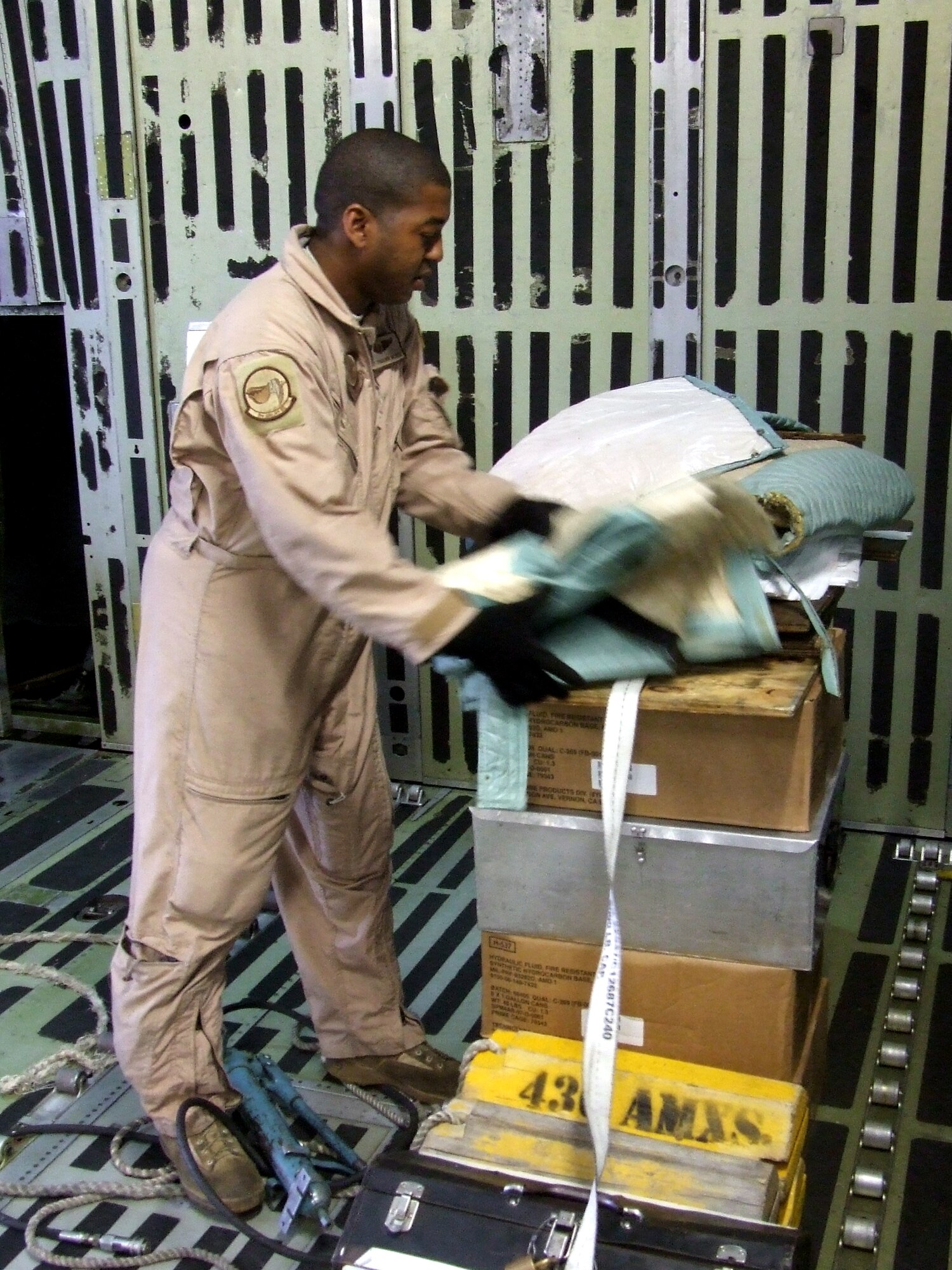 Staff Sgt. Tramainn McKee, C-5 Galaxy loadmaster, works in a C-5M Super Galaxy on June 5, 2011, prior to departing for a direct delivery airlift mission through the Arctic Circle from Dover Air Force Base, Del., to Bagram Airfield, Afghanistan. Sergeant McKee was one of 14 crewmembers who flew the mission. He is from the 9th Airlift Squadron at Dover AFB.  (U.S. Air Force Photo/Master Sgt. Scott T. Sturkol)