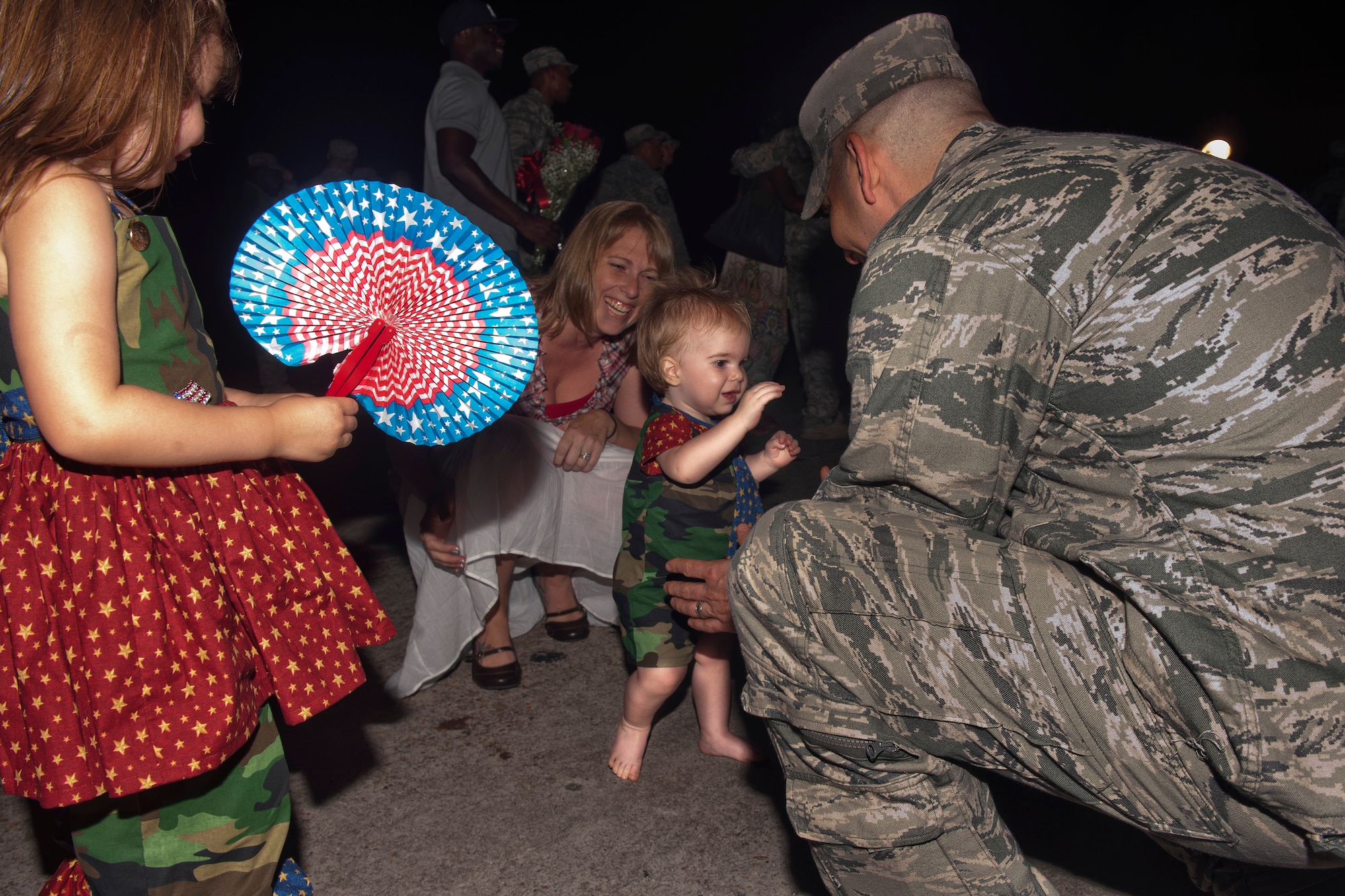 U.S. Air Force Staff Sgt. Joseph Brenner, 820th Combat Operations Squadron fire team leader, watches his son Caden walk for the first time after returning home June 11, 2011, at Moody Air Force Base, Ga. Sergeant Brenner was welcomed with open arms and showered with lots of love from his family after his six-month deployment to Afghanistan. (U.S. Air Force photo by Airman 1st Class Joshua Green/Released)
