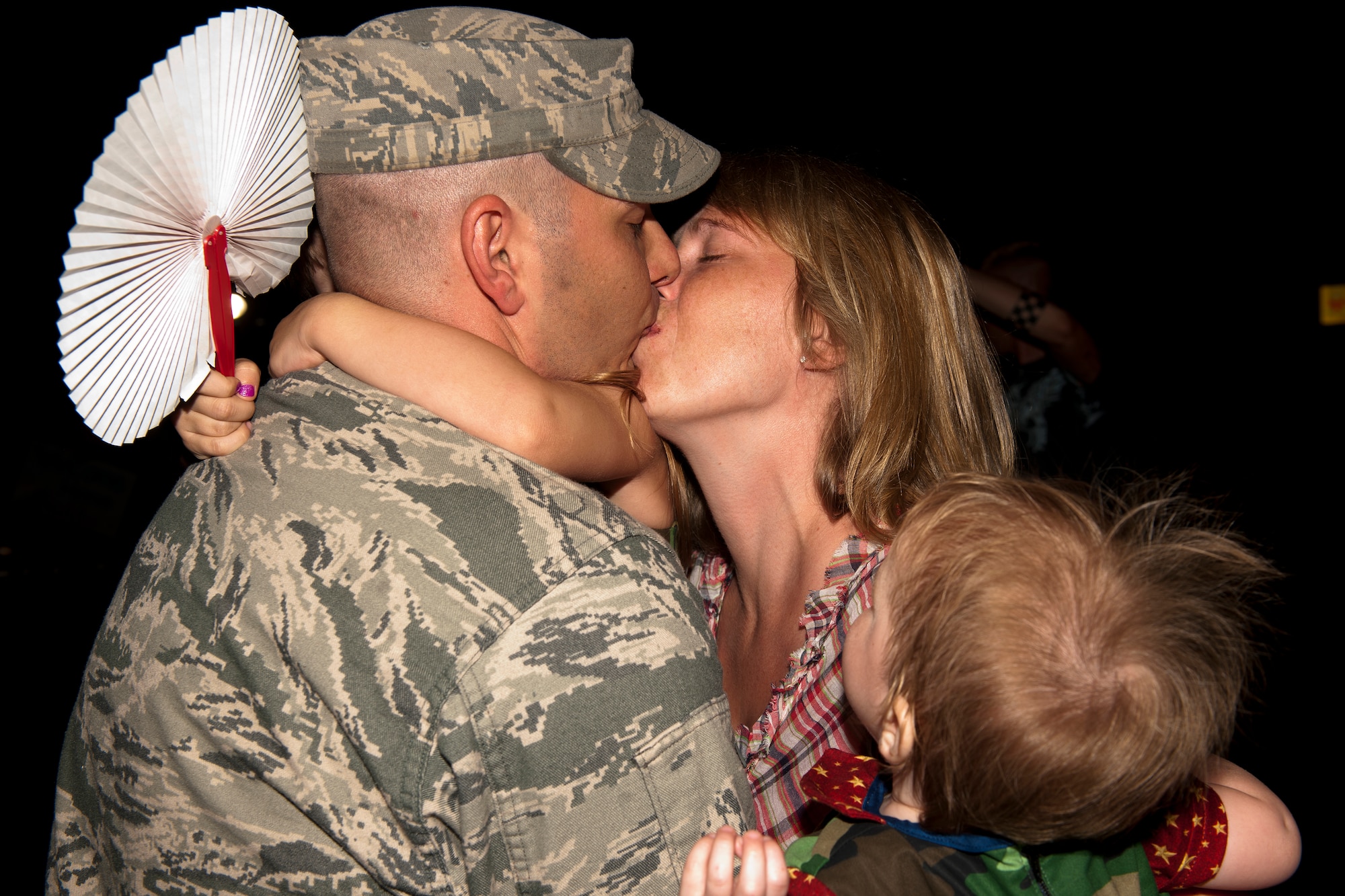 U.S. Air Force Staff Sgt. Joseph Brenner, 820th Combat Operations Squadron fire team leader, receives a welcome home kiss and embrace from his wife Trisha and children Angelina and Caden at Moody Air Force Base, Ga., June 11, 2011. Sergeant Brenner returned home from a six-month deployment in Afghanistan. (U.S. Air Force photo by Airman 1st Class Joshua Green/Released)
