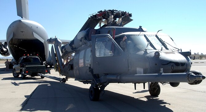 Personnel from the 943rd Maintenance Squadron prepare to tow an HH-60 Pave Hawk helicopter back to the 943rd MXS hangar, June 6 at Davis-Monthan Air Force Base, Ariz. The helicopter was returned to the 943rd Rescue Group after being gone for four years. During its time away from the unit, it served in numerous overseas combat missions. (U.S. Air Force photo/ Tech. Sgt. Luke Johnson)