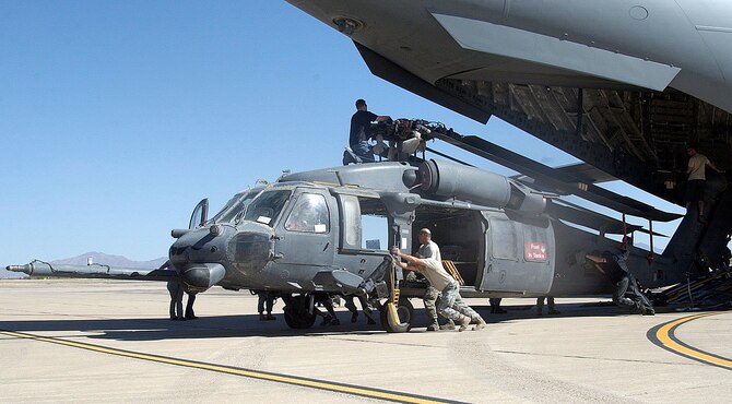 Personnel from the 943rd Maintenance Squadron offload an HH-60 Pave Hawk helicopter off of the back of a C-17 Globemaster III, June 6. The helicopter was returned to the 943rd Rescue Group at Davis-Monthan Air Force Base, Ariz. after being gone for four years. During its time away from the unit, it served in numerous overseas combat missions. (U.S. Air Force photo/ Tech. Sgt. Luke Johnson)