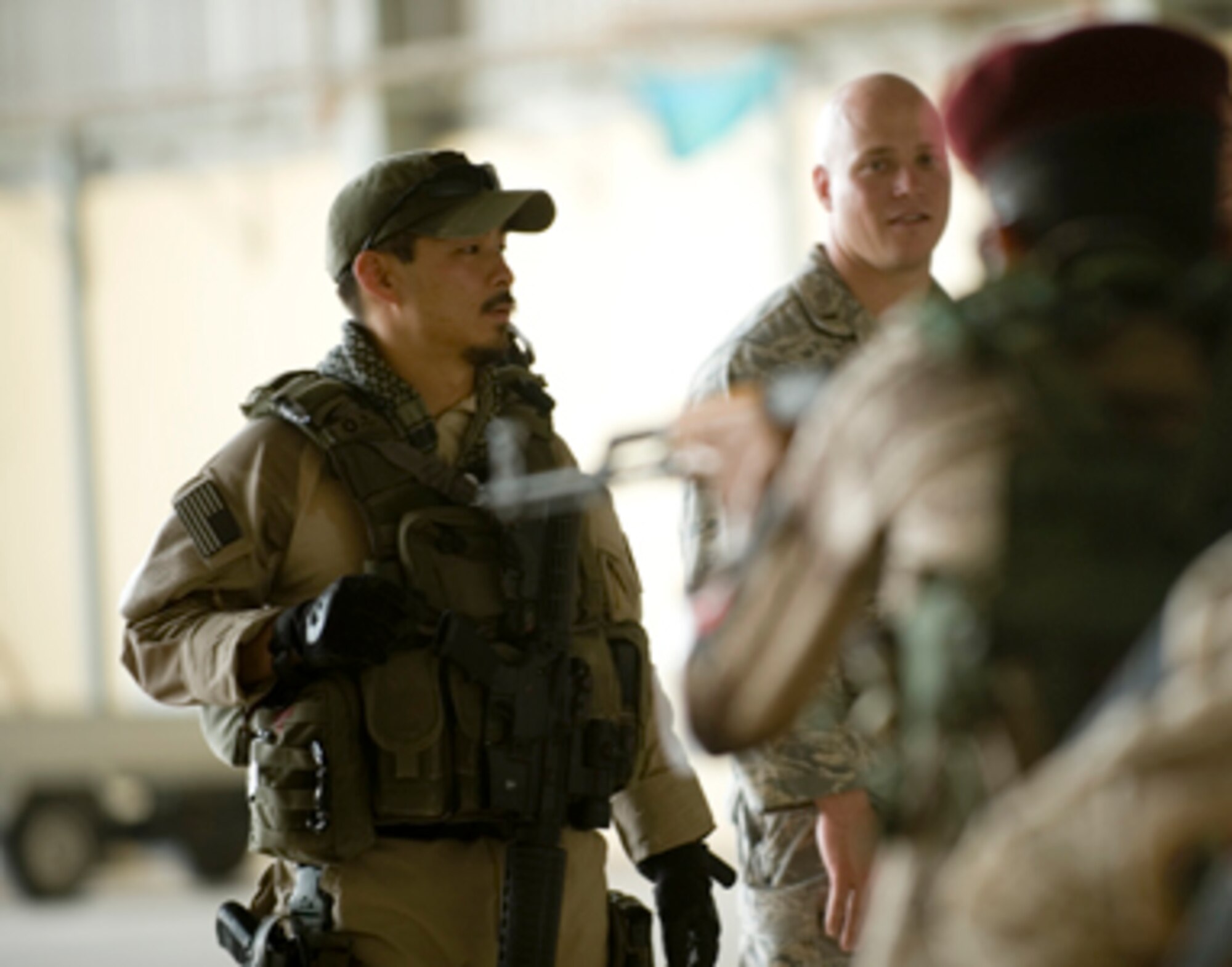Special Agent Masashi Yamazaki (left) instructs Iraqi security forces members on personal security operations June 1, 2011, at New Al Muthana Air Base, Iraq. The Iraqis were participating in personal security operations training to develop the skills needed to protect their leaders in future operations. (U.S. Air Force photo/Staff Sgt. Levi Riendeau) 