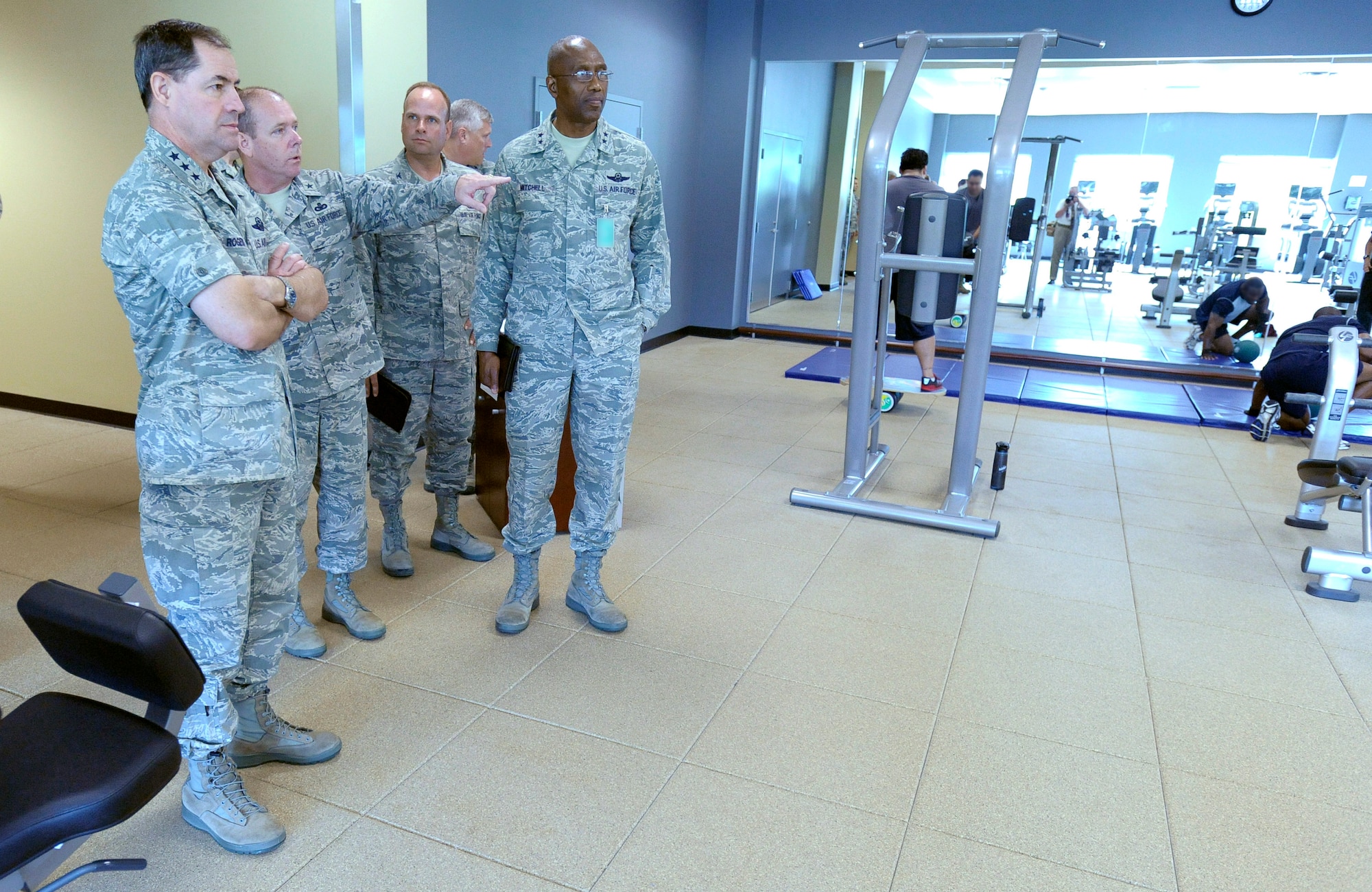 Lt. Gen. Marc E. Rogers, The Inspector General for the Air Force, far left, and Maj. Gen. Harold L. Mitchell, Deputy Inspector General of the Air Force, far right, listen to Brig. Gen. Kevin Jacobsen, AFOSI commander, second from left, talk about the fitness center located within the new AFOSI headquarters at Marine Corps Base, Quantico, Va. The TIG and DIG visited the AFOSI headquarters June 9 for the first time and received a special tour which ended in the state of the art, AFOSI commander's conference room. At the end of the tour, General Rogers presented the Legion of Merit Medal to General Jacobsen for his accomplishments while serving as the director of the Special Investigations Directorate in Washington, D.C. (U.S. Air Force Photo by Mr. Mike Hastings. Photo manipulated for security purposes by AFOSI Public Affairs.)