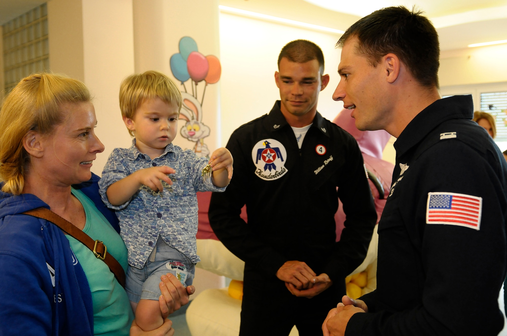 Staff Sgt. William Rotroff, U.S. Air Force Thunderbirds crew chief, and Capt. Nicholas Holmes, Thunderbirds pilot, speak to a mother and her child during a visit to the Pordenone Hospital Children's Wing June 11. The U.S. Air Force Thunderbird Air Demonstration Squadron visited Aviano Air Base, Italy, June 9-14 to perform in the Air Extreme 2011 Air Show in Jesolo, Italy. Team members also took the time to foster community relations in the surrounding area, and meet with junior enlisted Airmen. (U.S. Air Force photo/Senior Airman Katherine Windish)
