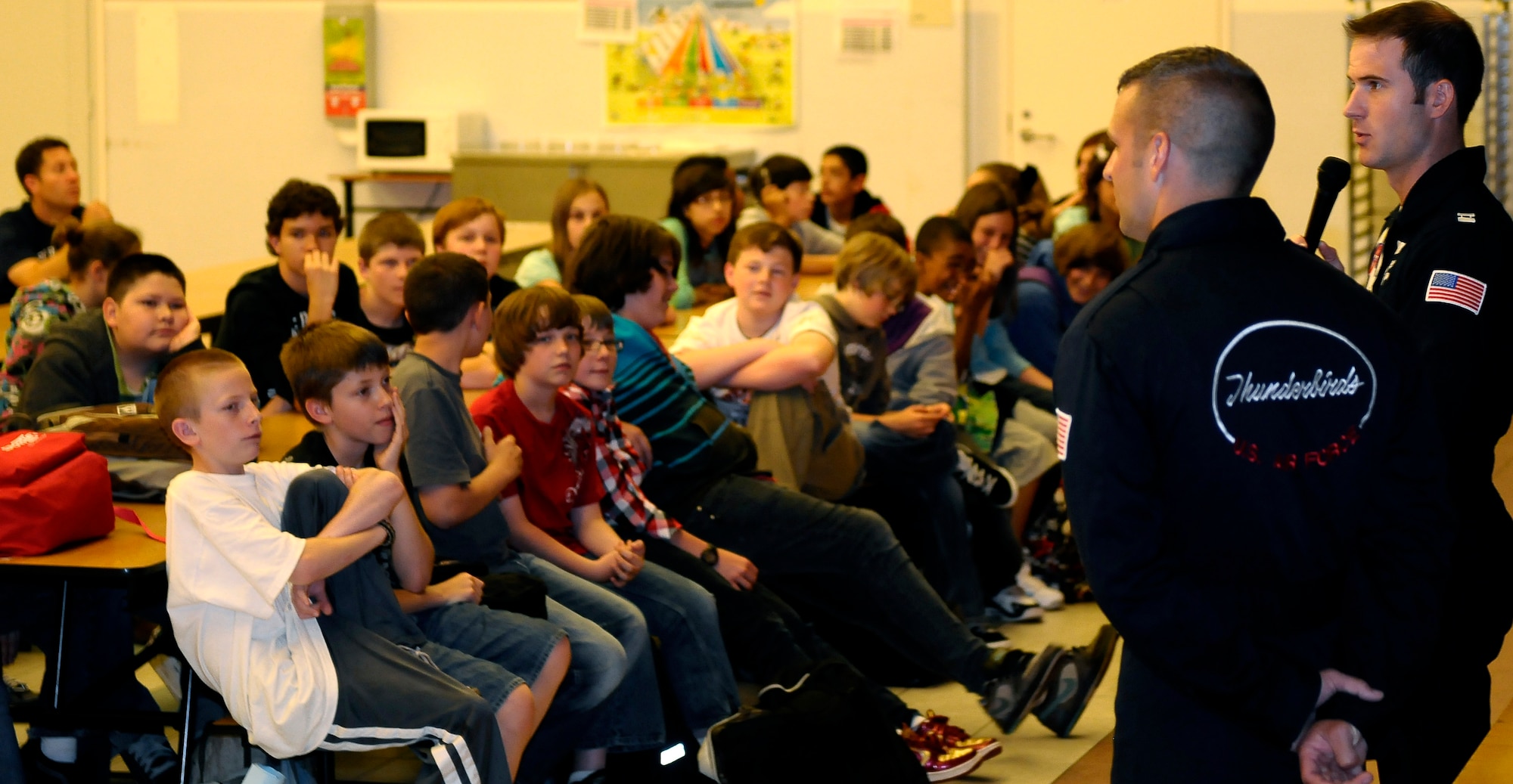 Capt. Ryan Riley, U.S. Air Force Thunderbirds pilot, and Staff Sgt. Mark Creel, Thunderbirds crew chief, speak to a group of Aviano middle and high school students about their future goals June 10. The U.S. Air Force Thunderbird Air Demonstration Squadron visited Aviano Air Base, Italy, June 9-14 to perform in the Air Extreme 2011 Air Show in Jesolo, Italy. Team members also took the time to foster community relations in the surrounding area, and meet with junior enlisted Airmen. (U.S. Air Force photo/Senior Airman Katherine Windish)