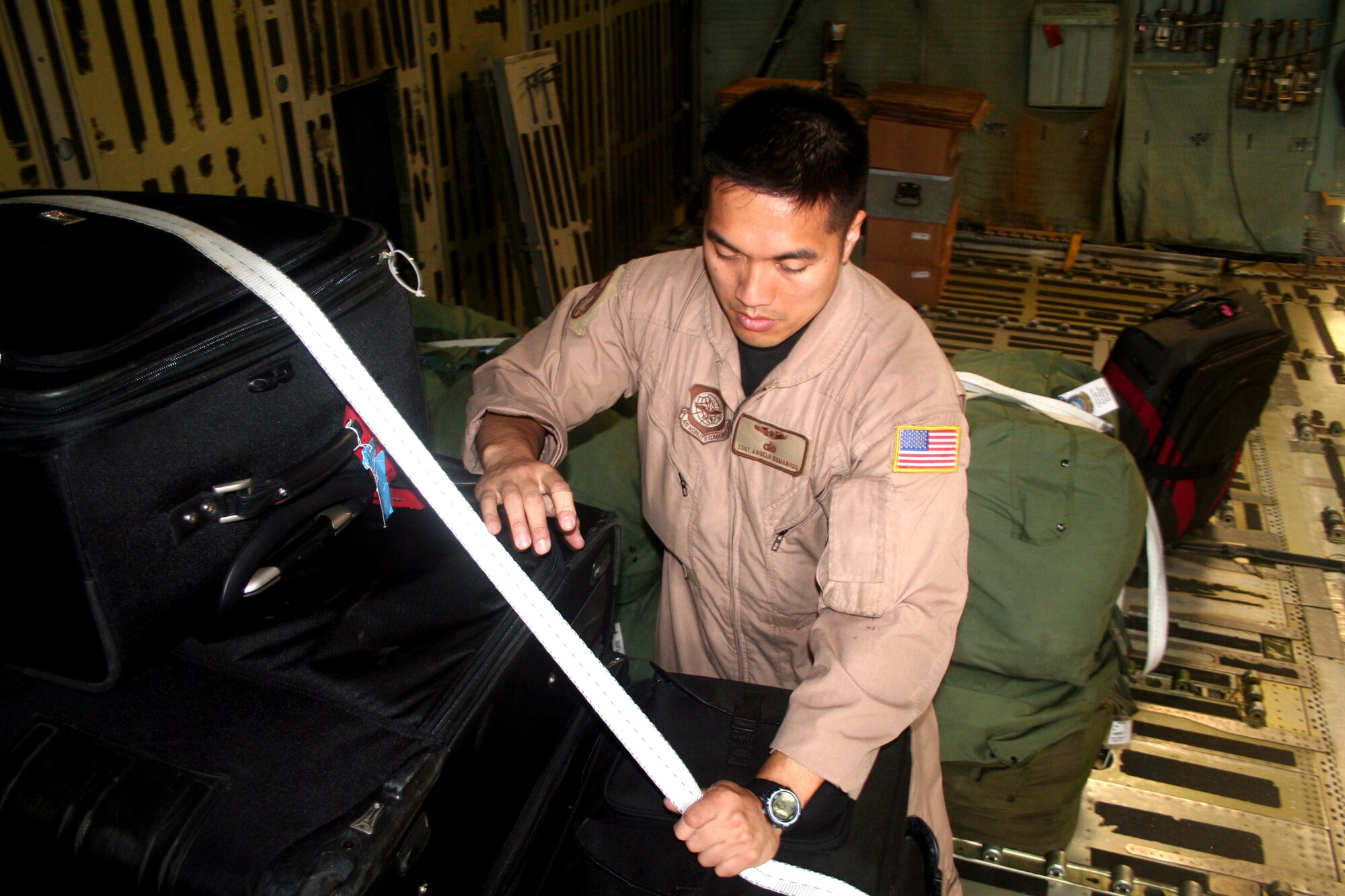 Staff Sgt. Angelo Dumanhog, C-5 Galaxy loadmaster, works in a C-5M Super Galaxy on June 5, 2011, prior to departing for a direct delivery airlift mission through the Arctic Circle from Dover Air Force Base, Del., to Bagram Airfield, Afghanistan. Sergeant Dumanhog was one of 14 crewmembers who flew the mission. He is from the 9th Airlift Squadron at Dover AFB.  (U.S. Air Force Photo/Master Sgt. Scott T. Sturkol)