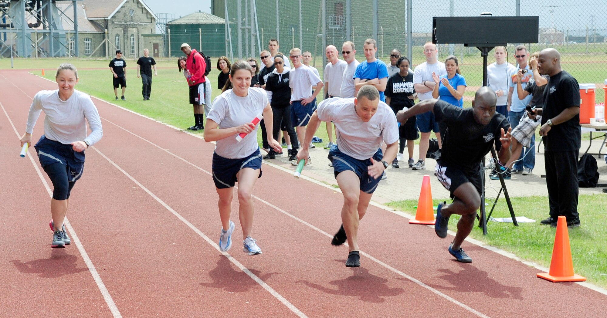 RAF MILDENHALL, England -- Airmen from the 100th Communications Squadron, 100th Force Support Squadron, 100th Logistics Readiness Squadron and the 100th Air Refueling Wing start off the 2,504 meter relay during the RAF Mildenhall Olympic Sport Challenge event June 10, 2011.  The relay was one of many events including rock wall climbing, volleyball and basketball. (U.S. Air Force photo/Senior Airman Ethan Morgan)