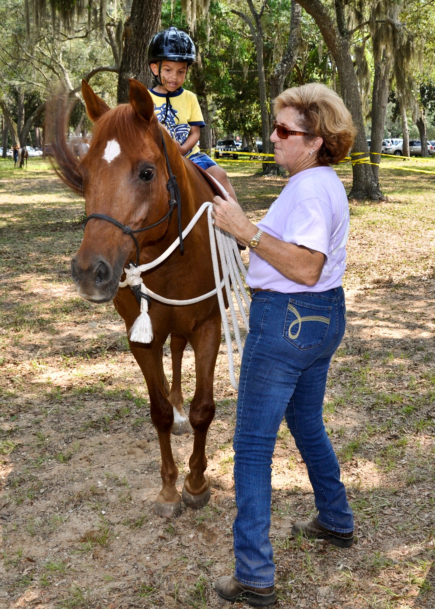 A little boy goes for a horseback ride at the Team Eglin Picnic at Post’l Point June 10.  Eglin personnel and their families enjoyed an afternoon complete with food, beverages and activities, including a water slide, bouncy house, climbing wall, face painting and horseback riding. (U.S. Air Force photo/Kevin Gaddie)
