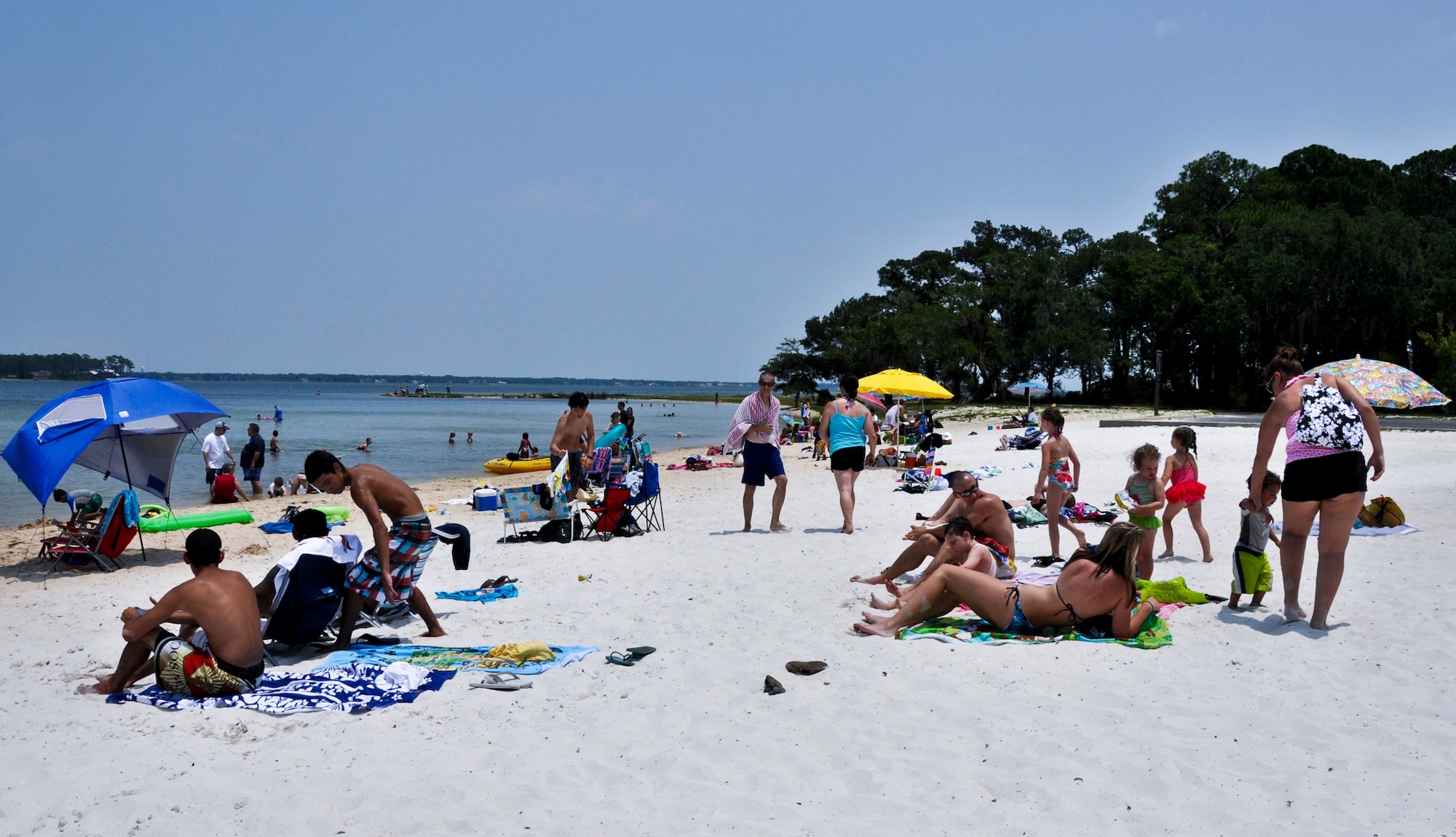 Beach goers bask in the sunshine at the Team Eglin Picnic at Post’l Point June 10.  Eglin personnel and their families enjoyed an afternoon complete with food, beverages and activities, including a water slide, bouncy house, climbing wall, face painting and horseback riding. (U.S. Air Force photo/Kevin Gaddie)
