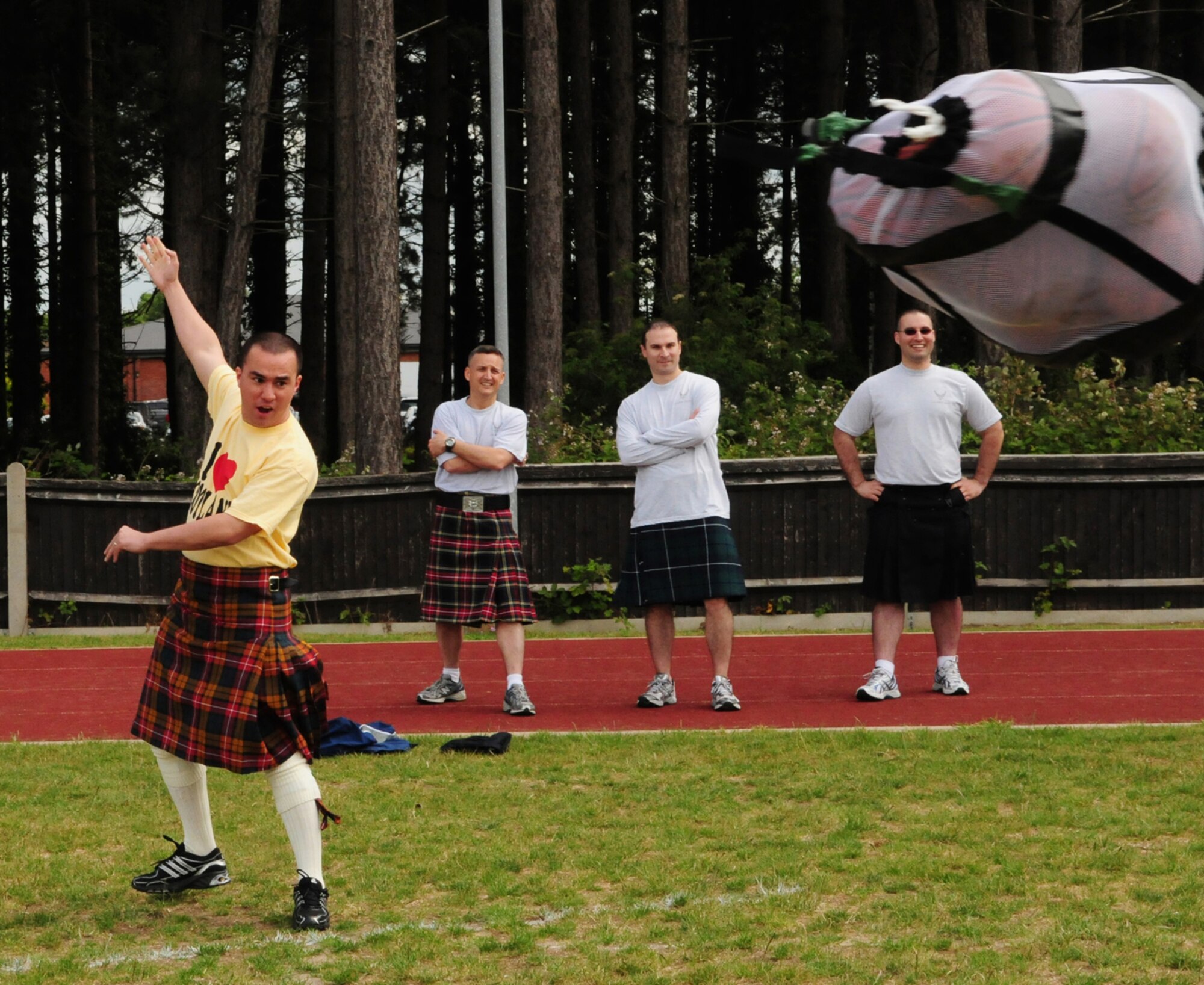 RAF MILDENHALL, England -- Staff Sgt. Thomas Long, 352nd Special Operations Maintenance Squadron, throws a bag of basketballs in the hope of getting them the furthest distance. The basketball toss required all participants had to wear a kilt and was one of many events in the Team Mildenhall Olympic Sports Challenge June 10, 2011. Other events included wall climbing, volleyball, basketball, soccer, bench press competition, flying disc throw and kettlebell walk. (U.S. Air Force photo/Karen Abeyasekere)