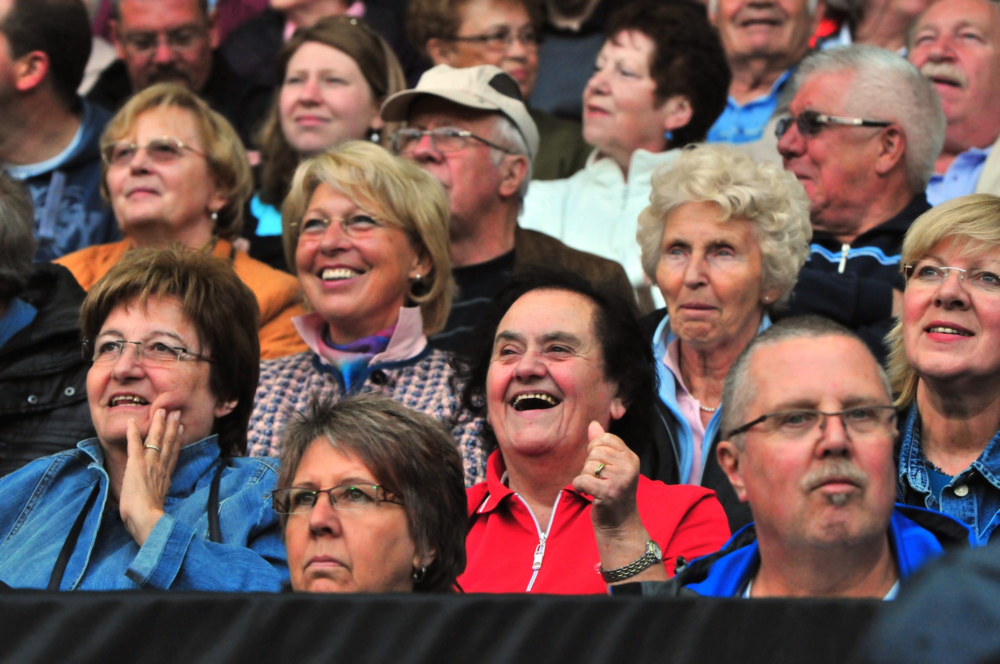 Those in attendance cheer as their nation's band performs during the 22nd Annual NATO Musikfestival, Fritz-Walter Stadion, Kaiserslautern, Germany, June 11, 2011.  Several hundred military musicians and bands from seven different nations performed musical selections influenced by their nation's culture and individual music styles.  (U.S. Air Force Photo by Tech. Sgt. Chenzira Mallory)
