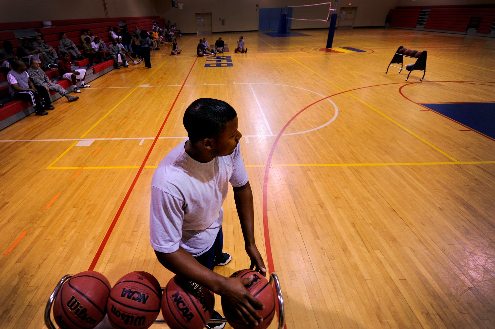 SHAW AIR FOCE BASE S.C. -- Senior Airman Chris Townsend, 20th Medical Group, reaches for a basket ball as he prepares to take his first shot during a 20th Force Support Squadron three-point shootout June 13, 2011. The shootout brought maximum participation among several squadrons and allowed Airmen and civilian contractors a chance to showcase their shooting skills and compete for a top spot. (U.S. Air Force photo by Senior Airman Kenny Holston)(Released)
