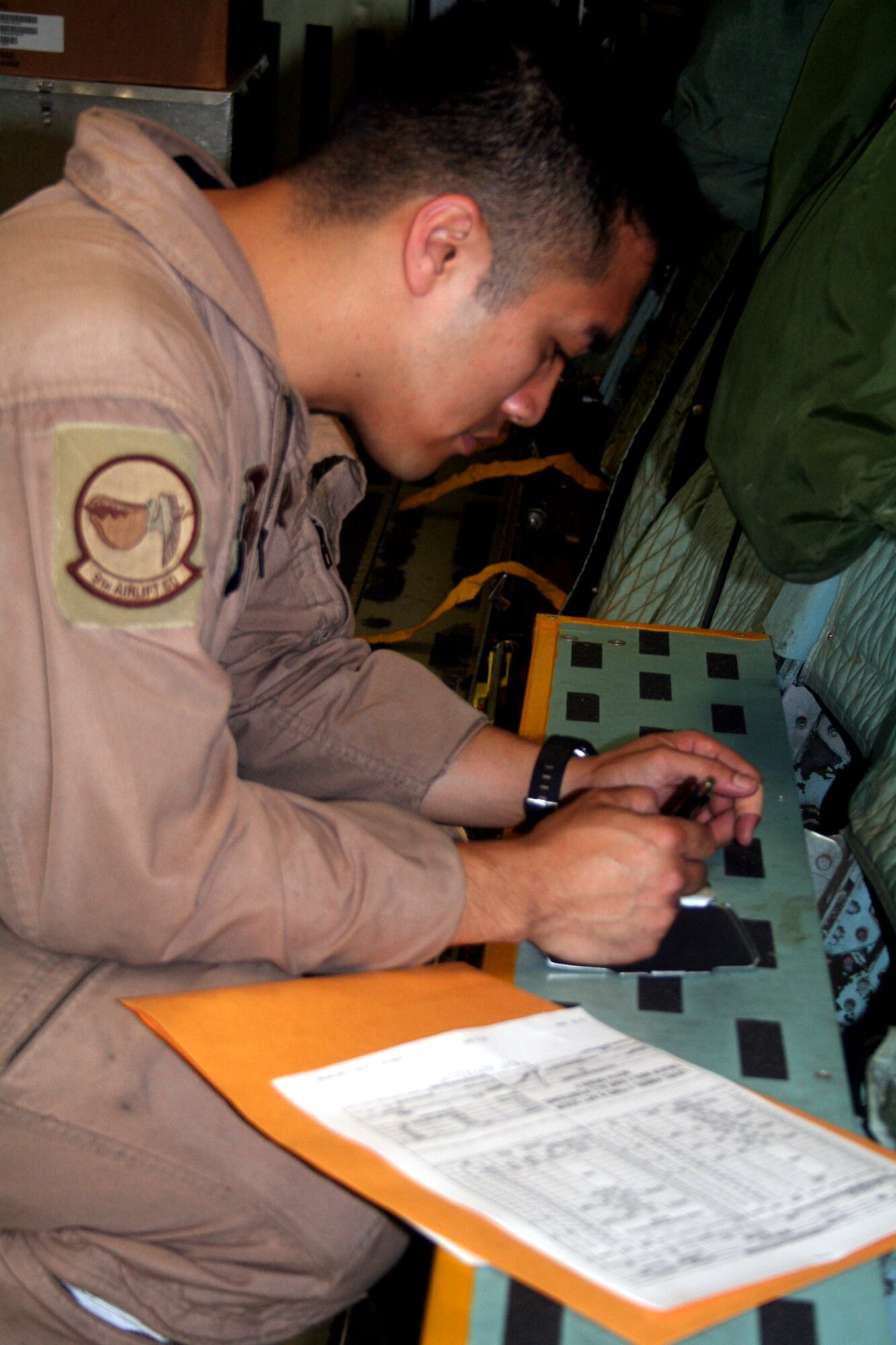 Staff Sgt. Angelo Dumanhog, C-5 Galaxy loadmaster, works in a C-5M Super Galaxy on June 5, 2011, prior to departing for a direct delivery airlift mission through the Arctic Circle from Dover Air Force Base, Del., to Bagram Airfield, Afghanistan. Sergeant Dumanhog was one of 14 crewmembers who flew the mission. He is from the 9th Airlift Squadron at Dover AFB.  (U.S. Air Force Photo/Master Sgt. Scott T. Sturkol)