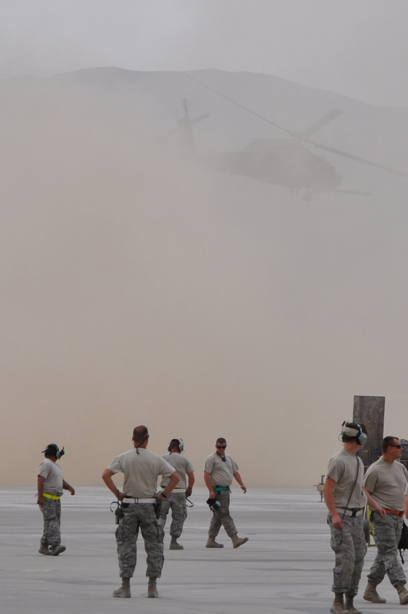 BAGRAM AIRFIELD, Afghanistan -- A HH-60G Pave Hawk helicopter full of pararescue Airmen from the 83rd Expeditionary Rescue Squadron slowly fades from sight, while ground crews look on, after taking off on a life-saving casualty evacuation mission here June 11. The quick response actions of the 83rd ERQS Airmen saved the lives of two wounded Afghan National Police in Kapisa Province, Afghanistan. It takes the 83rd ERQS an average of just 10 minutes from the time of notification to have a helicopter on its way to the fight. The 83rd ERQS aircrews are deployed from the 33rd Rescue Squadron at Kadena Air Base. The pararescue Airmen are deployed from the 31st Rescue Squadron, also at Kadena Air Base. (U.S. Air Force photo by Staff Sgt. John Wright)