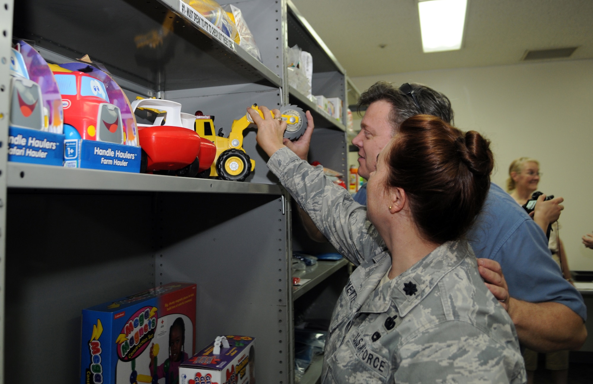 YOKOTA AIR BASE, Japan -- Terry Vedder and Lt. Col Carmen Goyette, Defense Logistics Agency commander, look at toys available at the Educational and Developmental Intervention Services lending library at Yokota Air Base, Japan, June 10, 2011. The lending library offers developmental toys, children books and educational resources for parents of children with special needs. (U.S. Air Force photo/Airman 1st Class Krystal M. Garrett) 