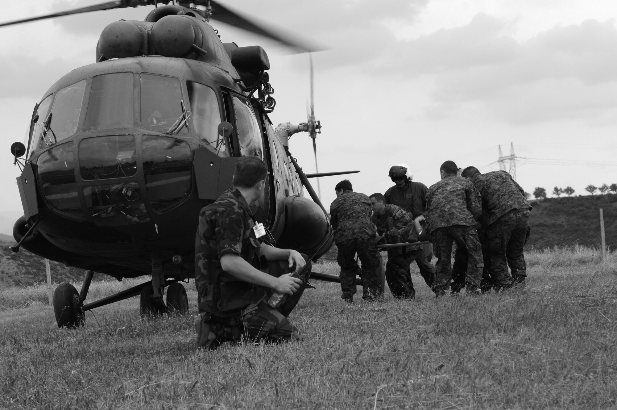 CAMP PEPELISHTE, Macedonia -- Multinational medical personnel race to a Macedonian MI-17 with a simulated trauma patient as part of a medical transport flight on a patient during the 2011 Medical Training Exercise in Central and Eastern Europe live exercise June 12. An annual Chairman of the Joint Chiefs of Staff-sponsored regional and multilateral exercise, MEDCEUR is designed to provide medical training and operational experience in a deployed environment for U.S. and partner nations. The countries participating in this year's MEDCEUR are Macedonia, Montenegro, Bosnia and Herzegovina, Serbia, Slovenia and Norway. (U.S. Air Force photo/Master Sgt. Kelley J. Stewart)