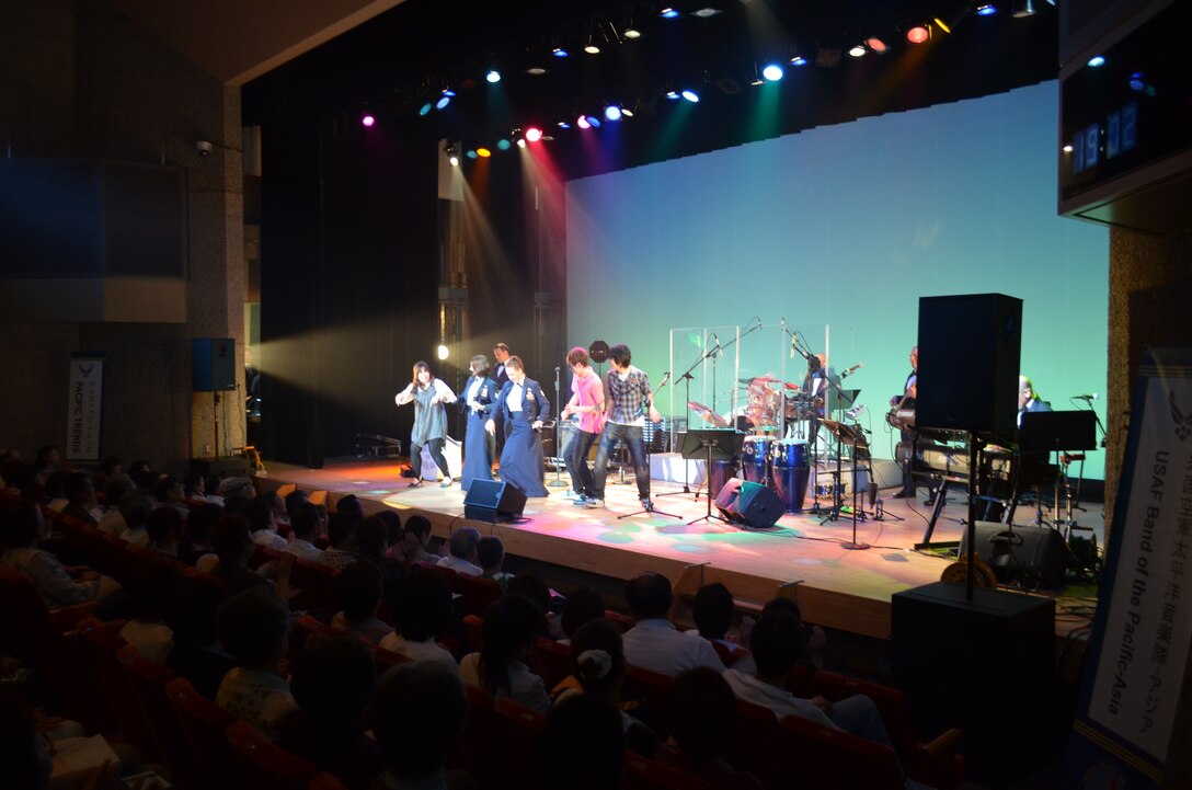 Audience members dance with the band in Miyagi.