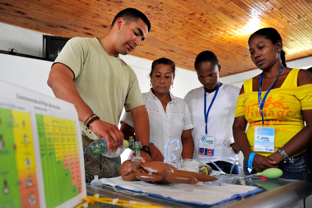 U.S. Air Force Staff Sgt. Nibaldo Colina, left, shows Colombian nurses how to ventilate a newborn child during a Babies Can Breathe training session and subject matter expert exchange during Continuing Promise 2011 in Tumaco, Colombia, June 8, 2011. Nibaldo is a spanish-speaking linguist.