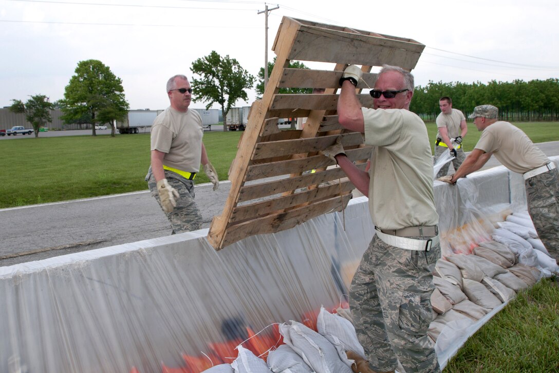 Air Force Col. Andy Halter carries an empty pallet during sandbagging efforts outside Rosecrans Memorial Airport, St. Joseph, Mo., June 9, 2011. Halter is the commander of the 139th Maintenance Group, Missouri Air National Guard.