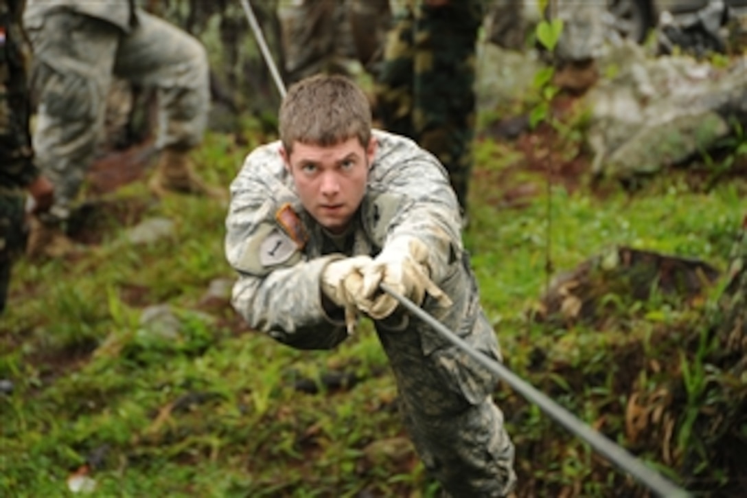 Sgt. Johnathan Oberholz crosses a one-rope bridge during an infantry  subject matter expert exchange.