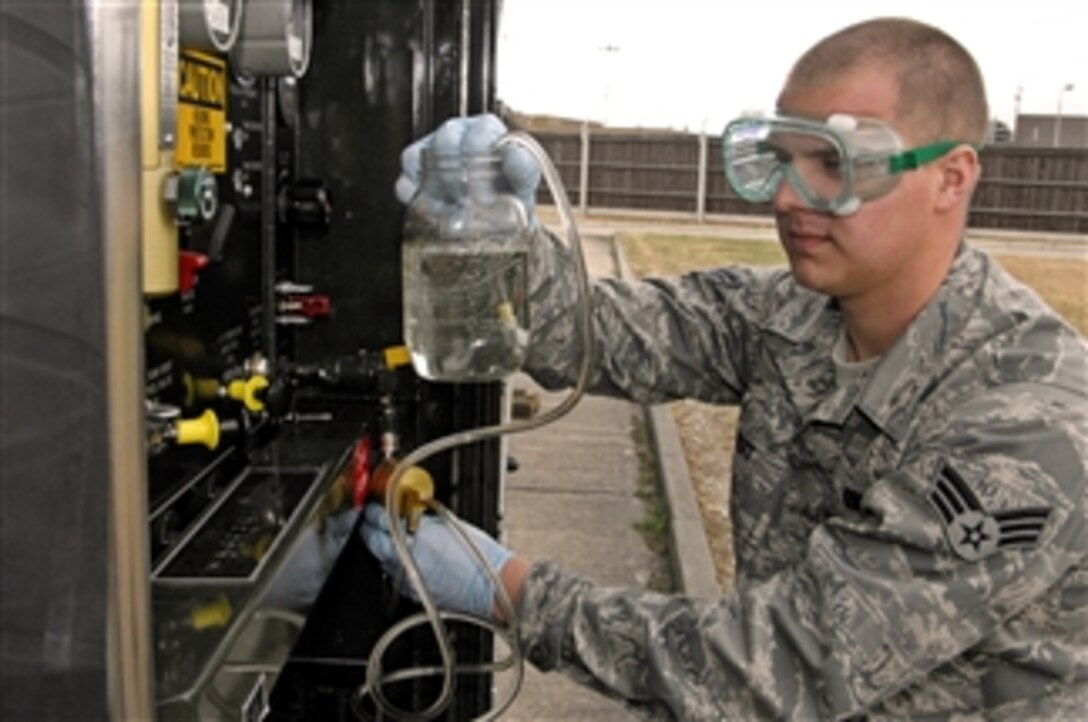 Senior Airman Justin Gilbert collects a fuel sample for testing at Royal Air Force Lakenheath, England, on May 26, 2011.  Gilbert is a fuels laboratory technician assigned to the 48th Logistics Readiness Squadron.  