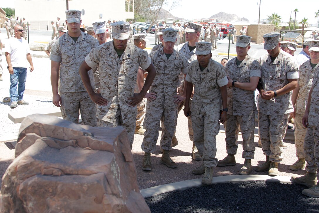 Marines and sailors of 3rd LAR pause to reflect at their new memorial dedicated to the Wolf Pack Marines who lost their lives during Operation Iraqi Freedom after the dedication ceremony of their memorial park June 14, 2011 in front of the 3rd LAR headquarters building.::r::::n::