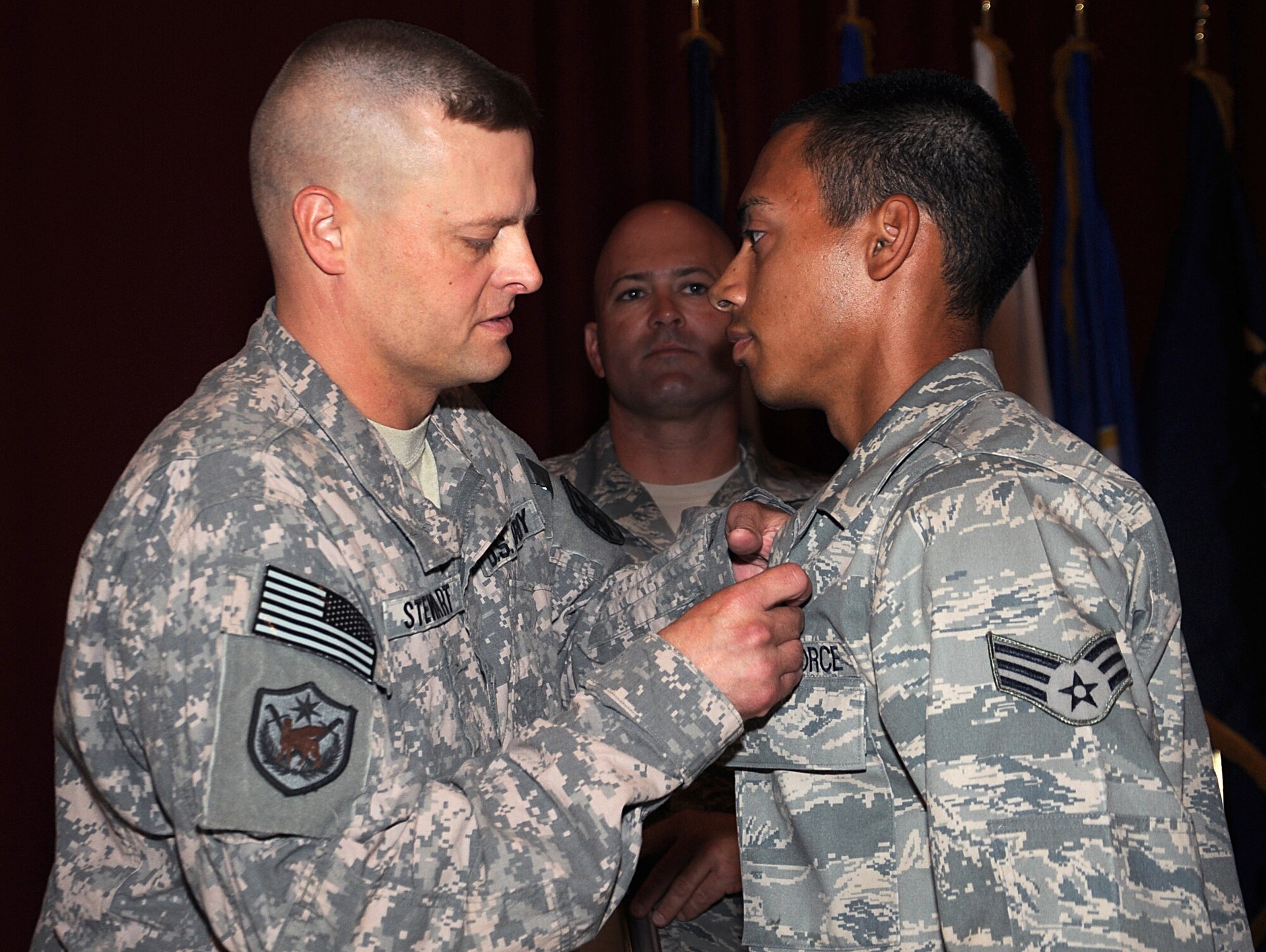 Senior Airman Kenny Gonzalez receives the U.S. Army Combat Action Badge during an official ceremony in Southwest Asia June 9. Airman Gonzalez is a combat trucker with the 387th Expeditionary Logistics Readiness Squadron. Airman Gonzalez's vehicle was struck by an improvised explosive device while on a convoy in Iraq as part of the Joint Logistics Task Force 6, 70th Medium Truck Detachment in direct support of Operations New Dawn and Iraqi Freedom. (U.S. Air Force photo by Senior Airman Cynthia Spalding)