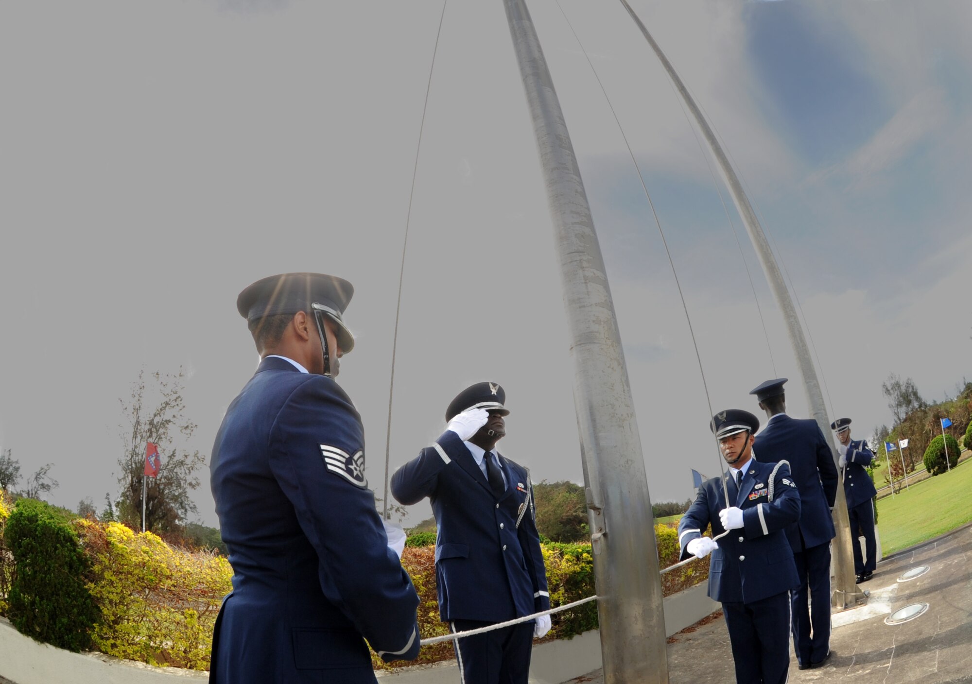 Kadena Honor Guardsmen lower the flags during retreat at the 2011 Air Force Sergents Association Flag Day Ceremony, June 14, Kadena Air Base, Japan. During this ceremony, unserviceable flags were retired honorably by being burned. (U.S. Air Force photo/Airman 1st Class Jarvie Z. Wallace)
